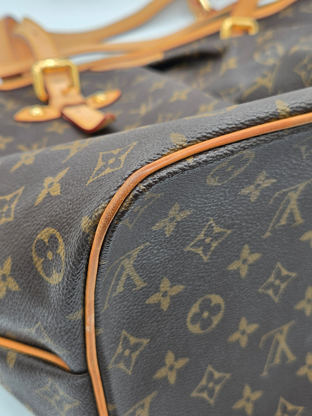 Close-up of a Louis Vuitton monogram bag with gold hardware.