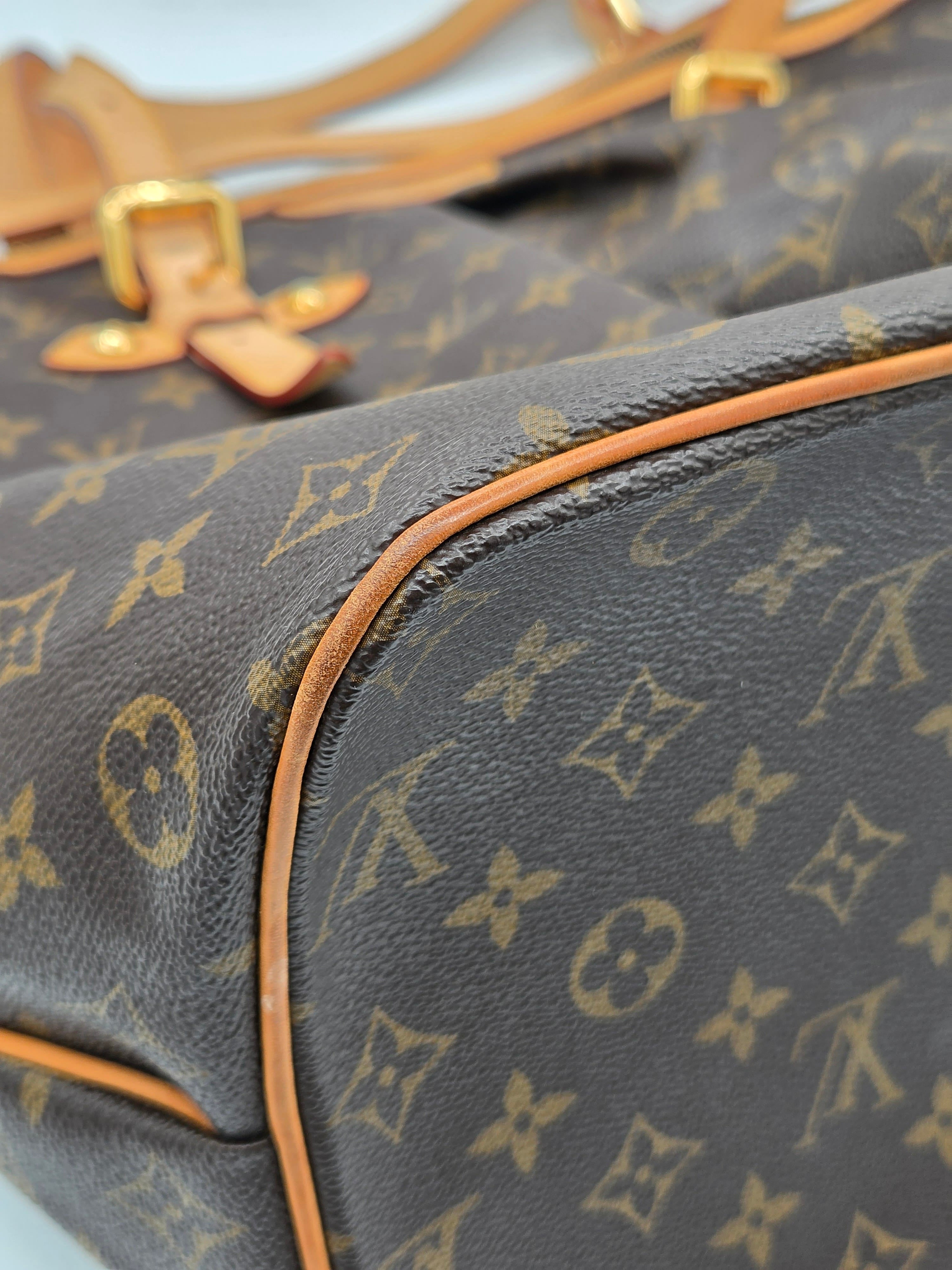 Close-up of a Louis Vuitton monogram bag with gold hardware.