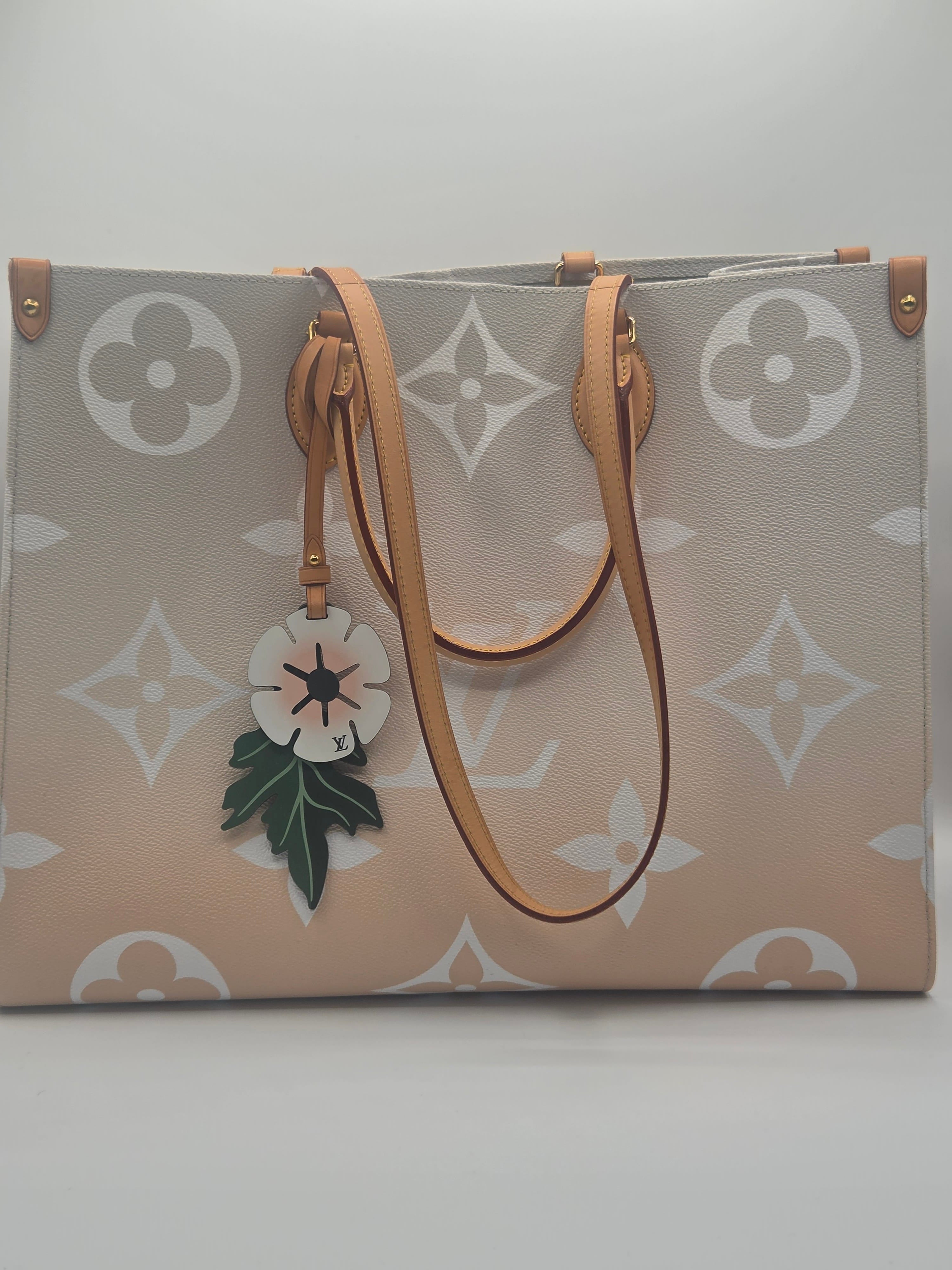 Designer handbag with floral charm on a light background