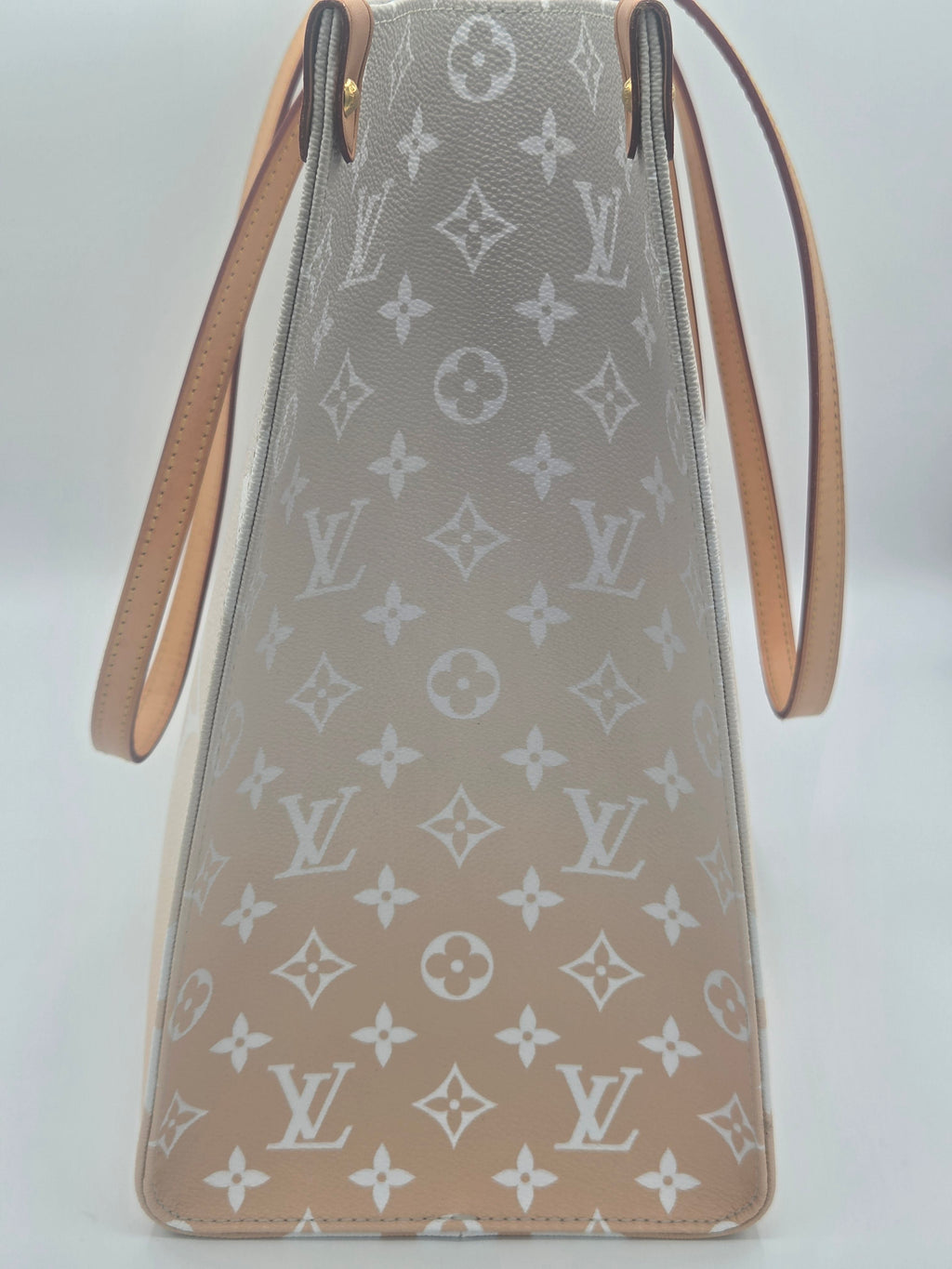 Designer handbag with monogram pattern on a light background