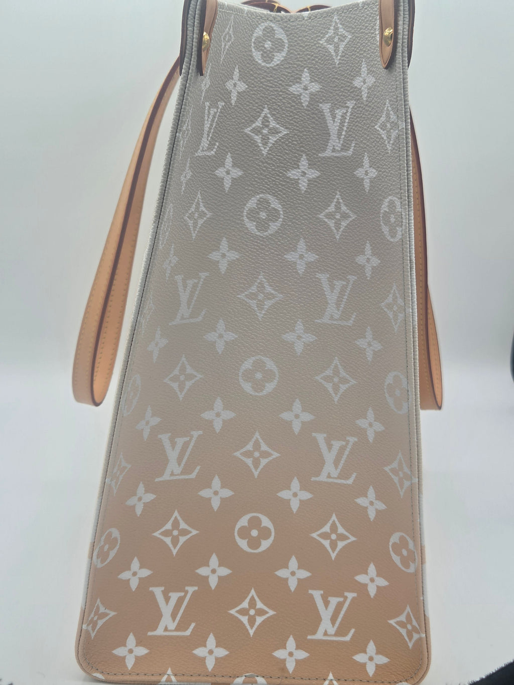 Designer handbag with monogram pattern on a white background