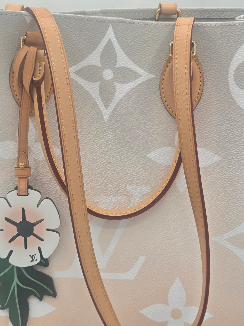 Designer handbag with floral design and visible brand logo