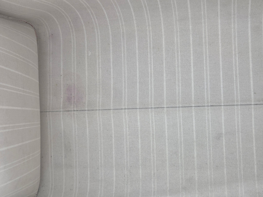 Close-up of a textured concrete wall with horizontal lines.