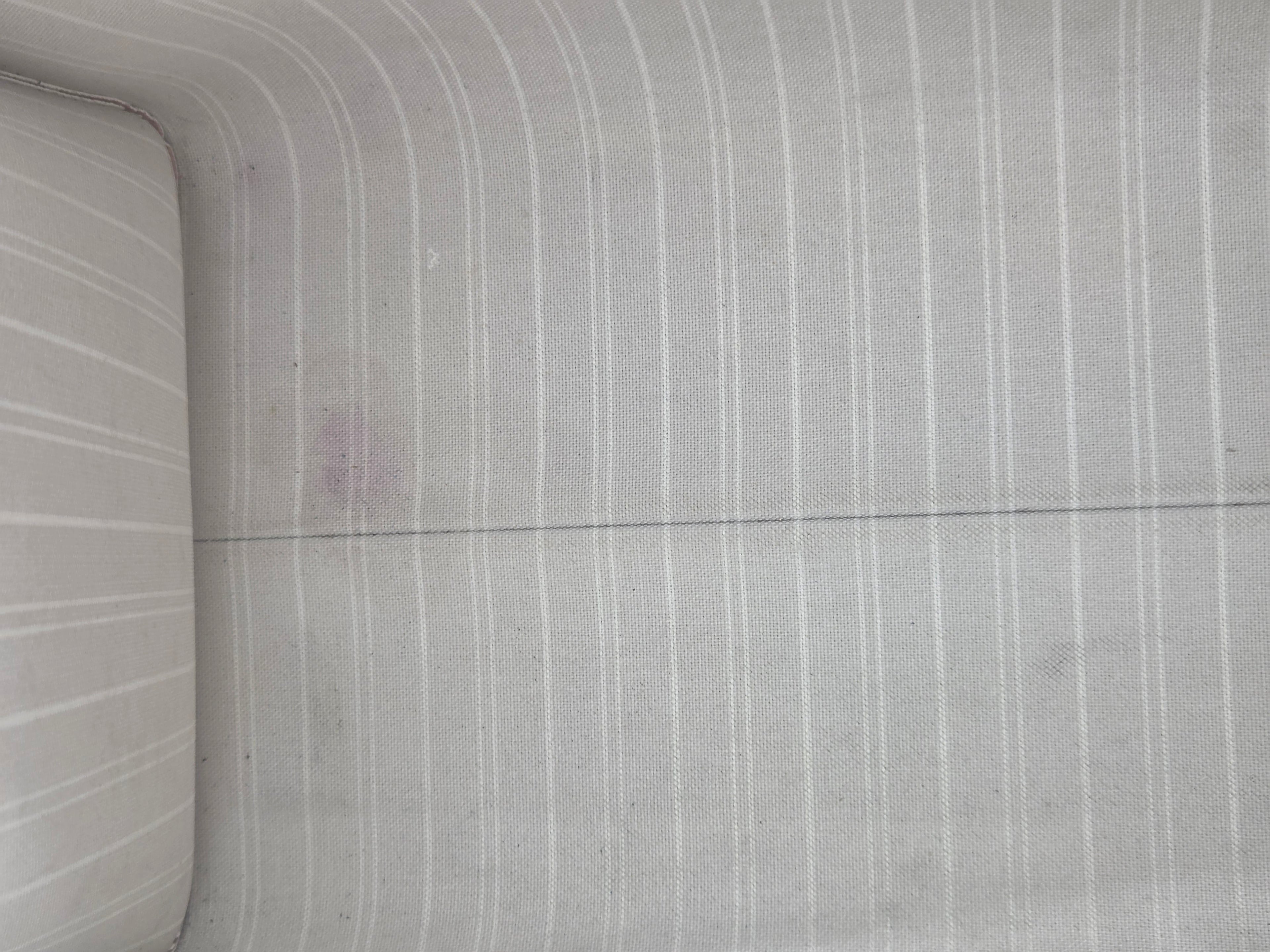 Close-up of a textured concrete wall with horizontal lines.