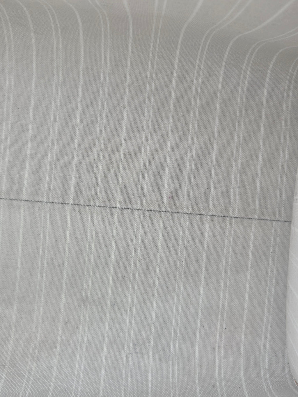 Close-up of gray fabric with subtle texture and lines