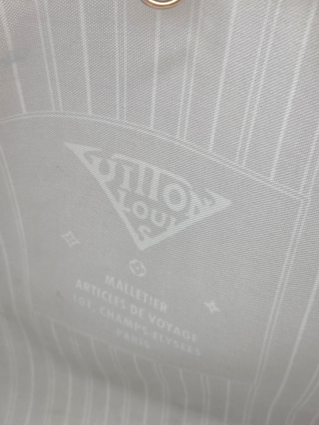 Close-up of a gray fabric with a brand logo and text.