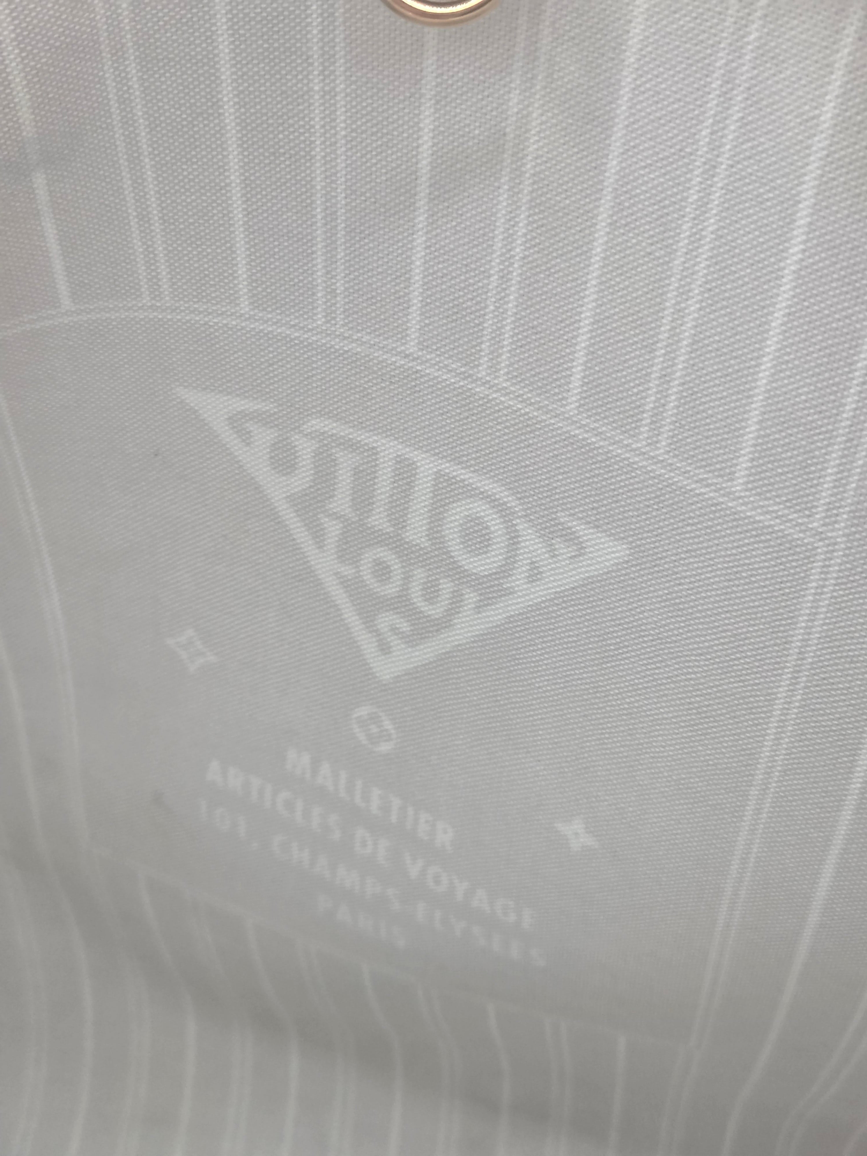 Close-up of a gray fabric with a brand logo and text.