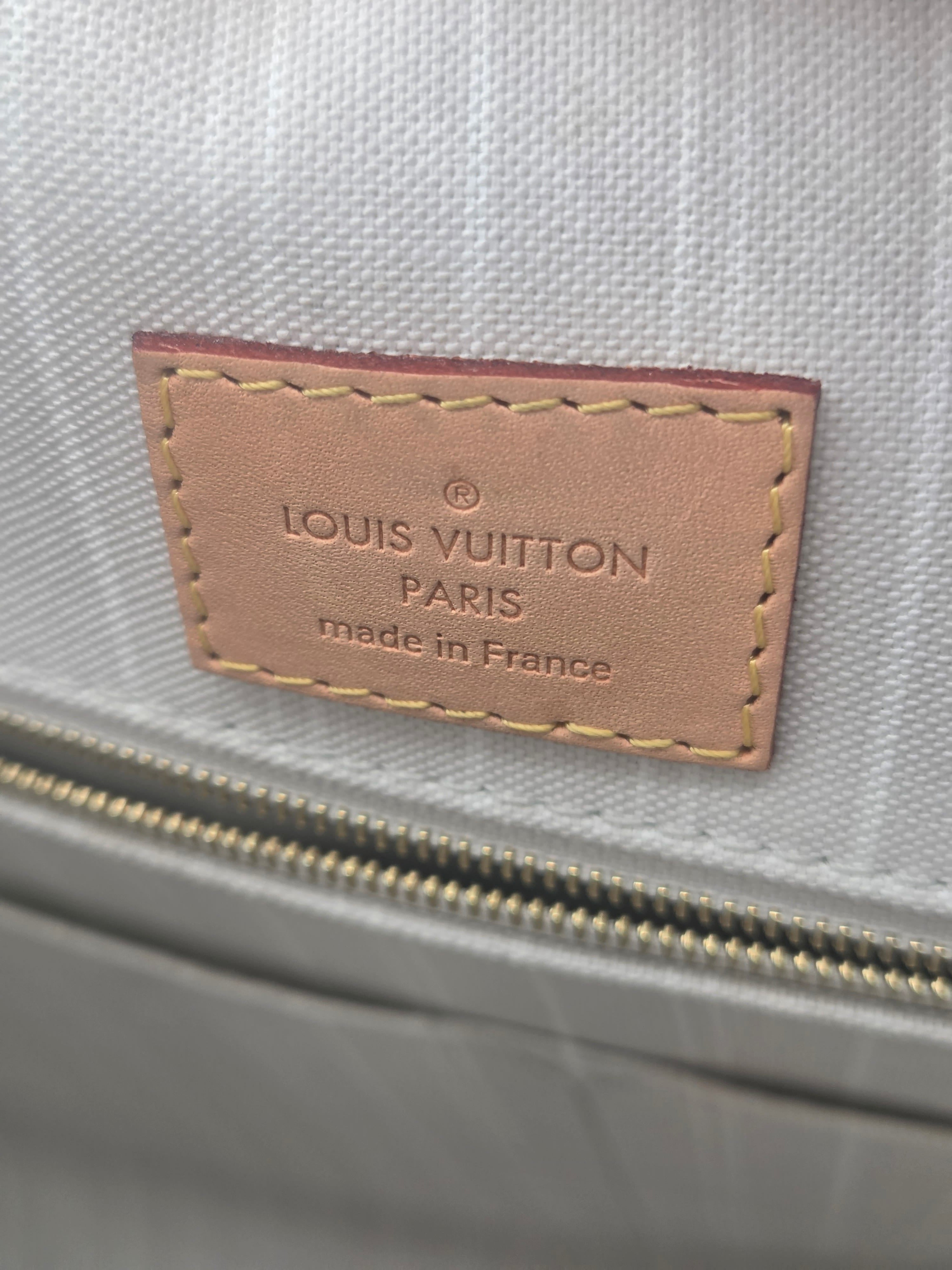 Louis Vuitton label on a gray textured surface