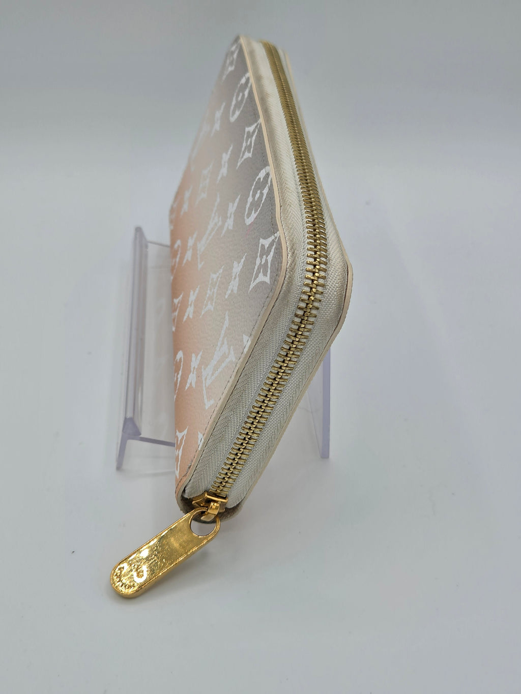 Small pouch with gold zipper on a white background