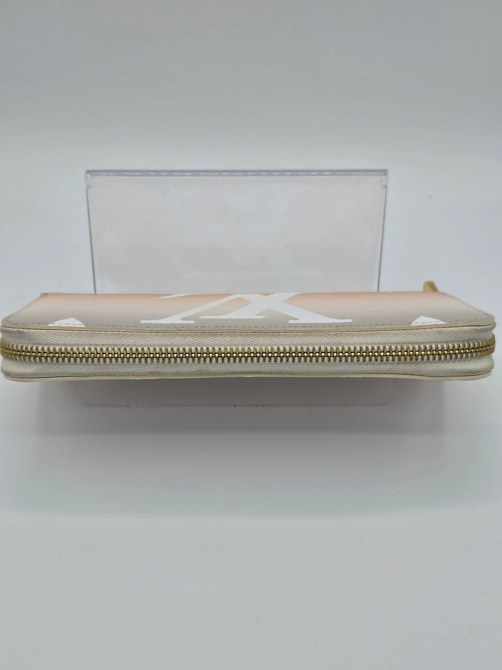 Clear pouch with a gold zipper on a white background