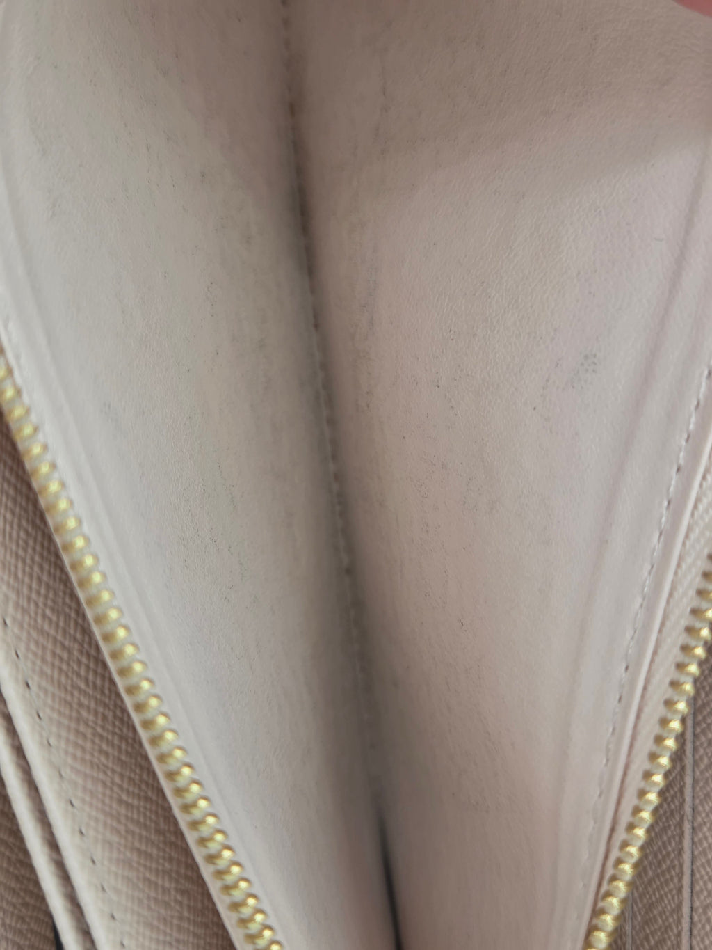 Close-up of a beige fabric surface with a zipper