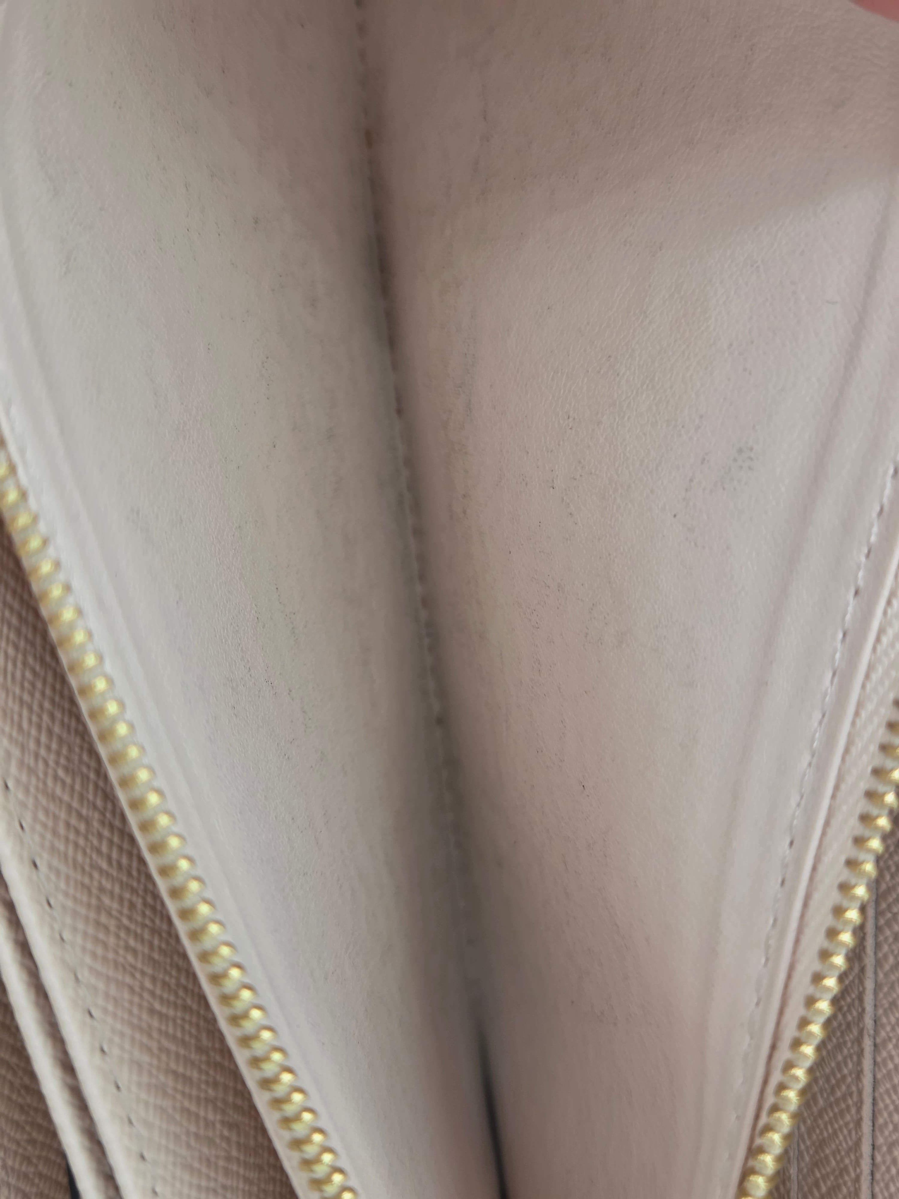 Close-up of a beige fabric surface with a zipper