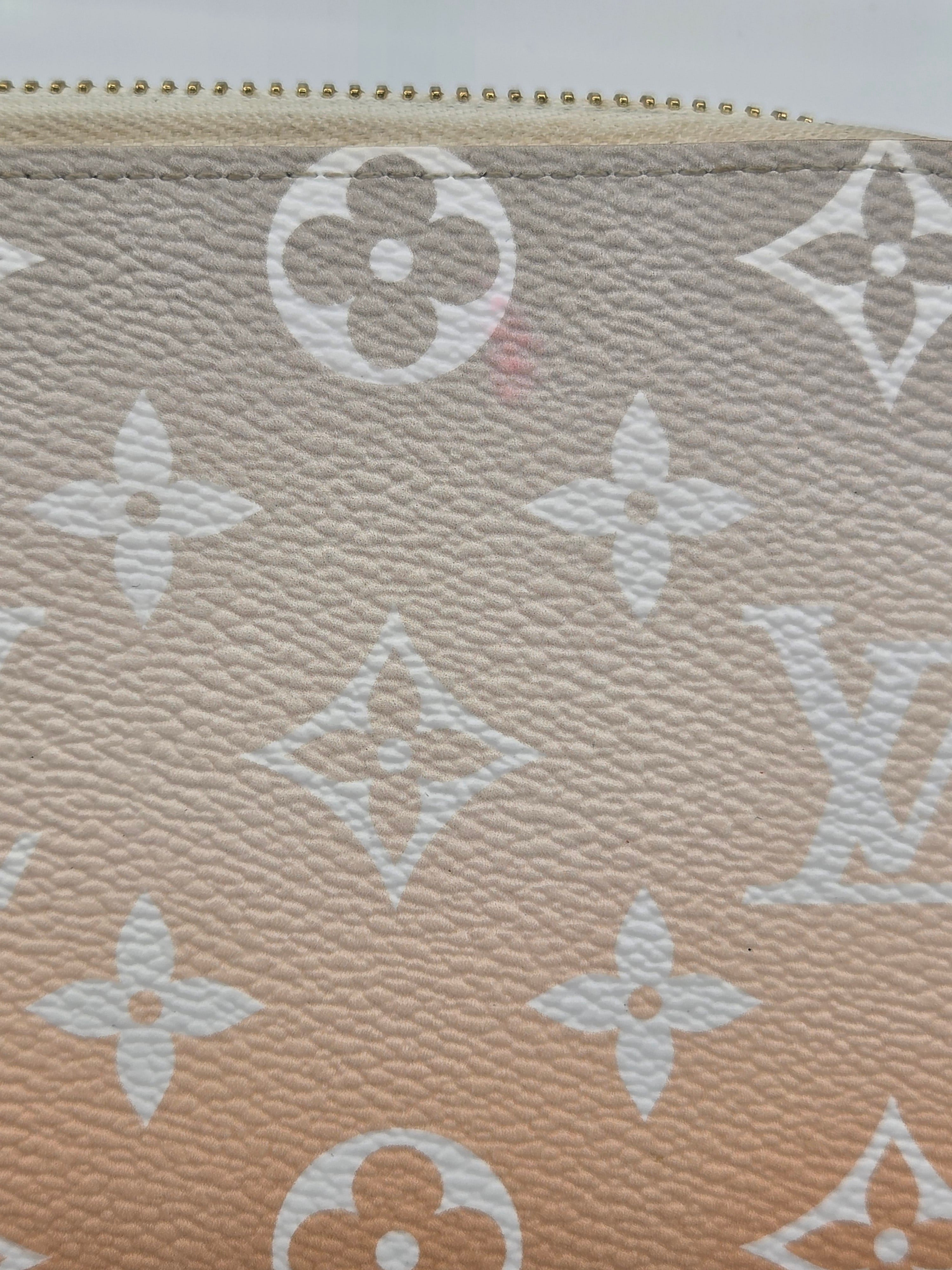 Close-up of a beige fabric with a white logo pattern