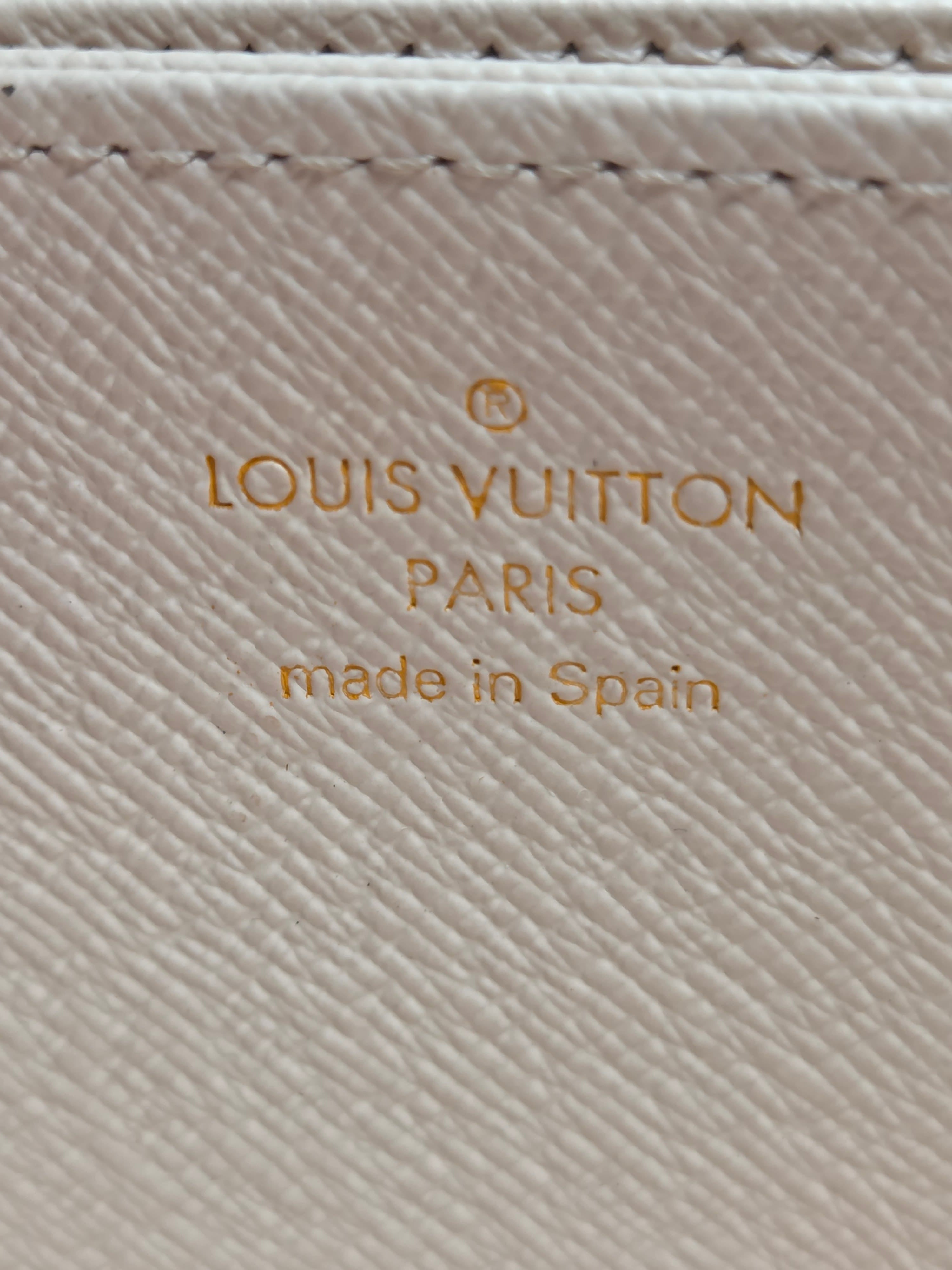 Louis Vuitton logo on a textured beige surface