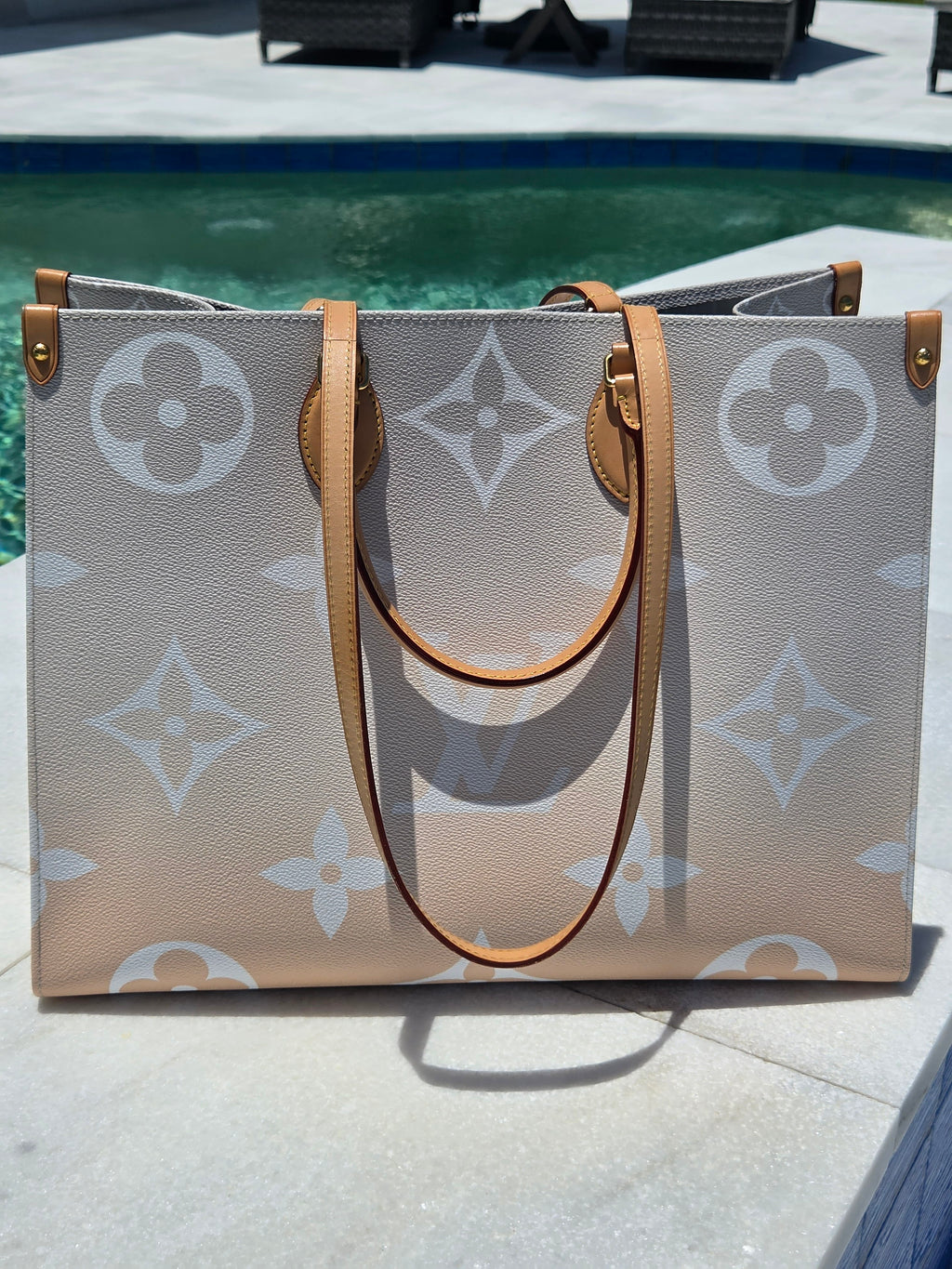 Designer handbag with monogram pattern on a textured surface