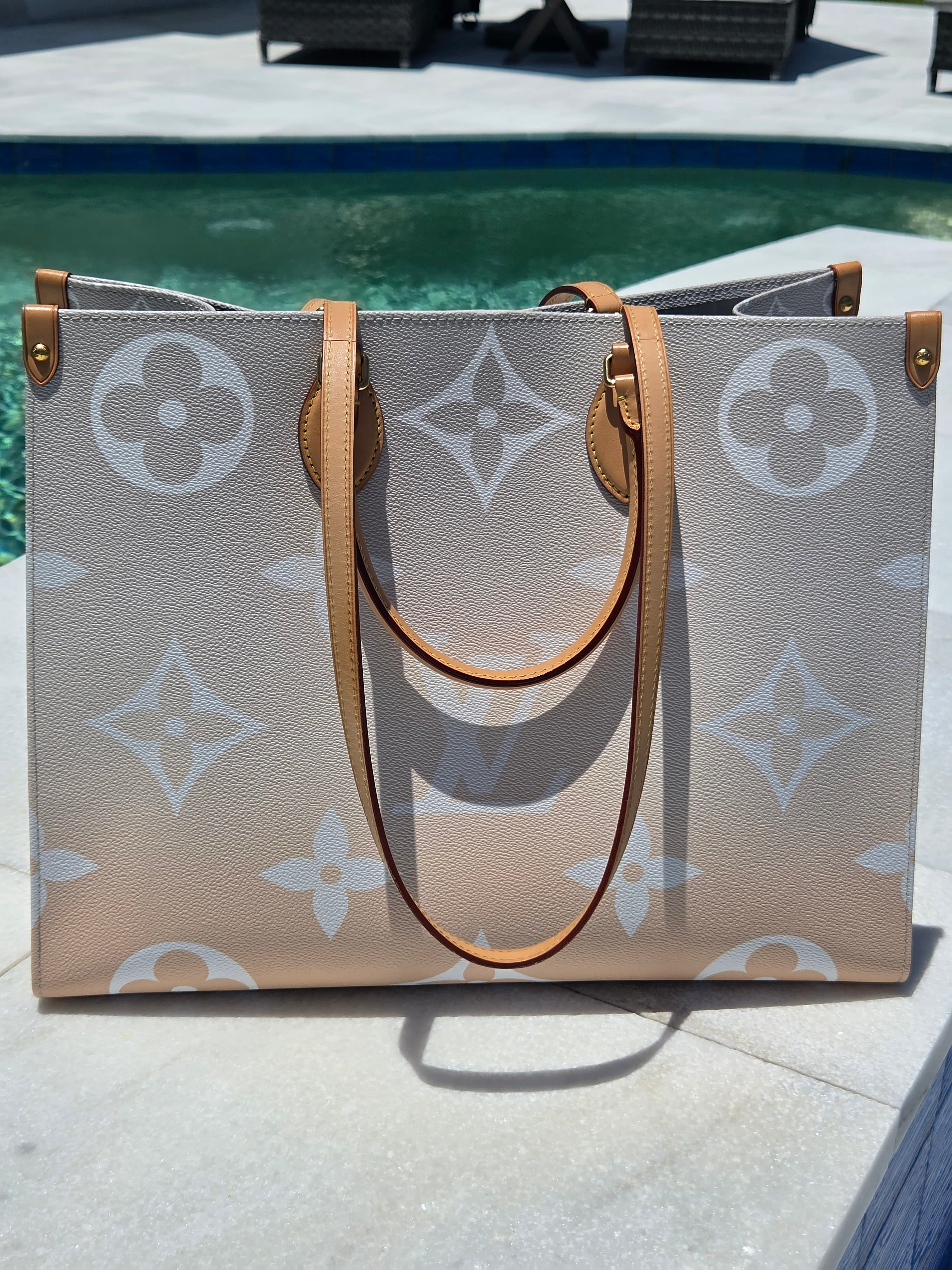 Designer handbag with monogram pattern on a textured surface