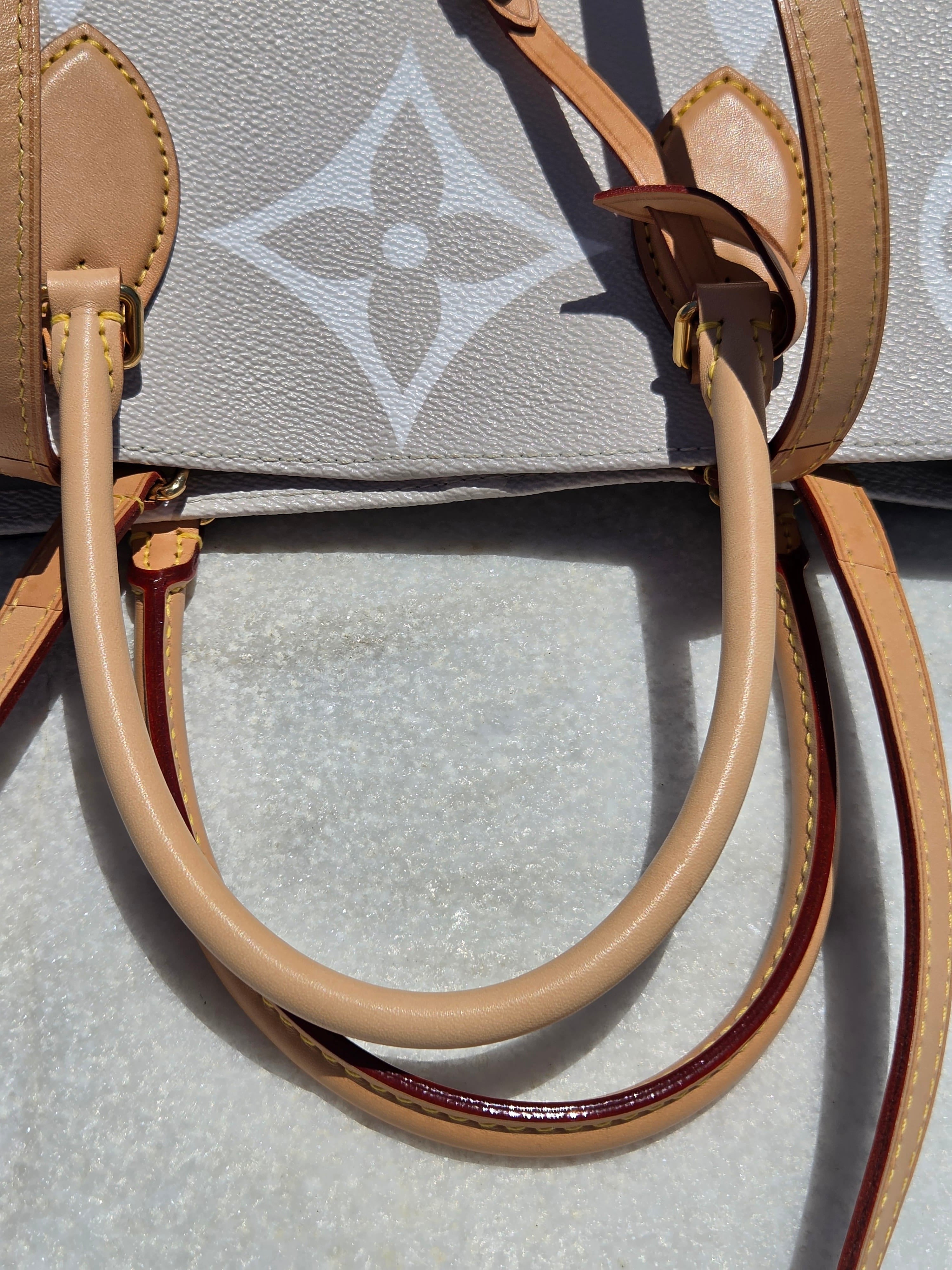 Close-up of a beige leather handle on a patterned surface