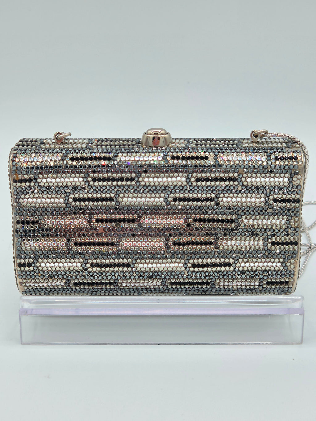 Decorative clutch with a pattern of small beads on a light gray background