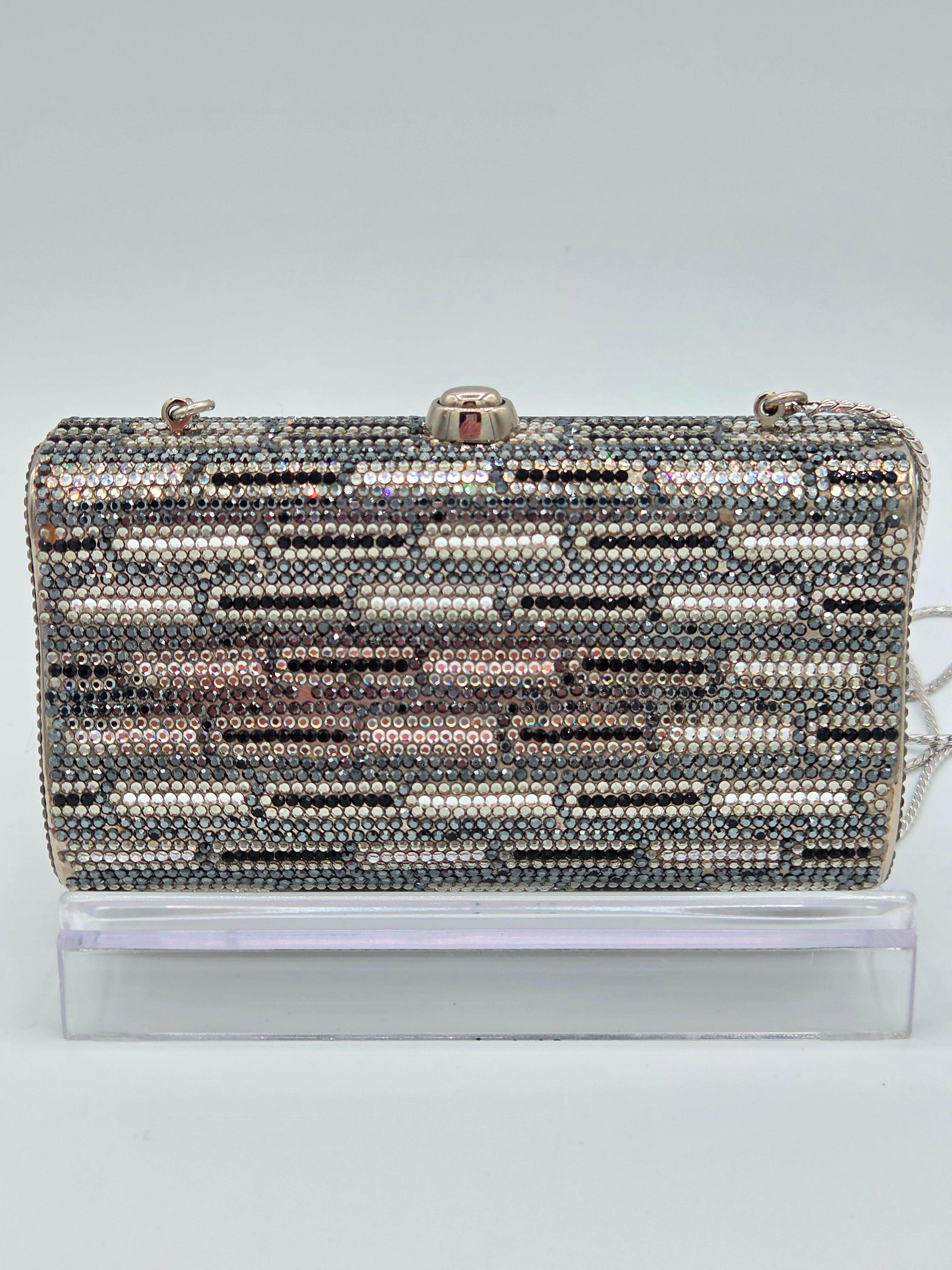 Decorative clutch with a pattern of small beads on a light gray background