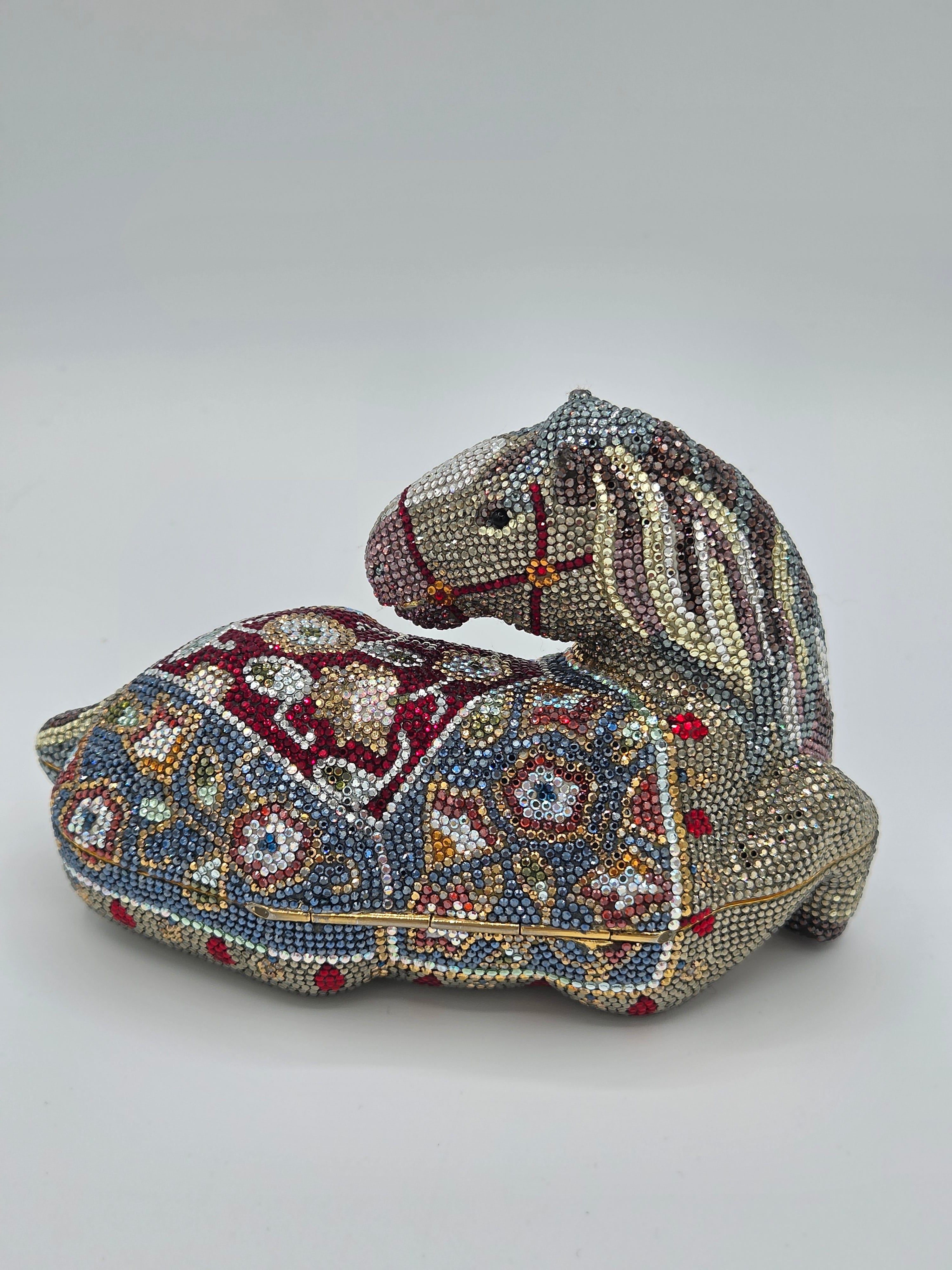 Decorative horse head sculpture with intricate beadwork on a plain background