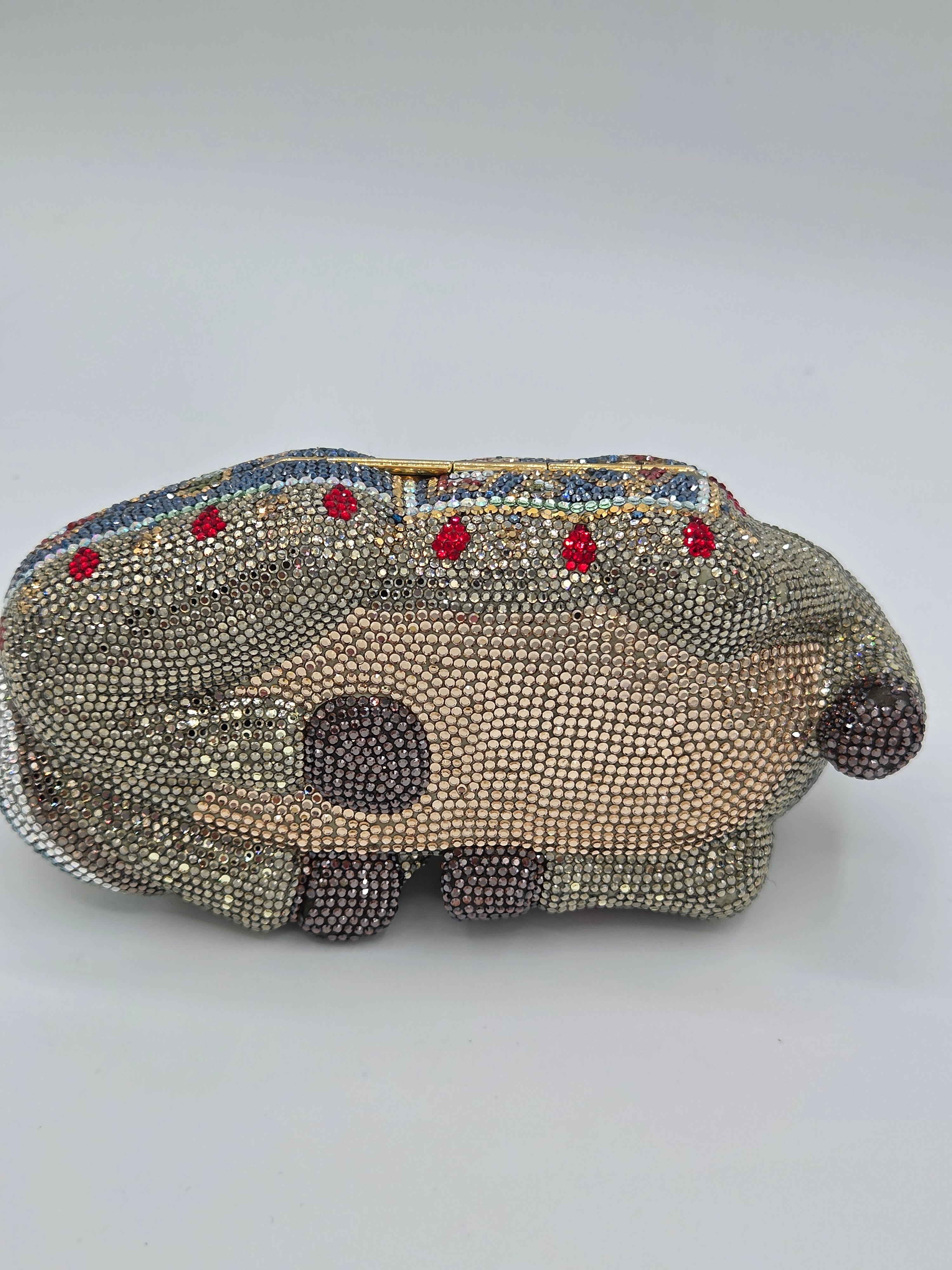 Decorative mask with beadwork and colored stones on a gray background