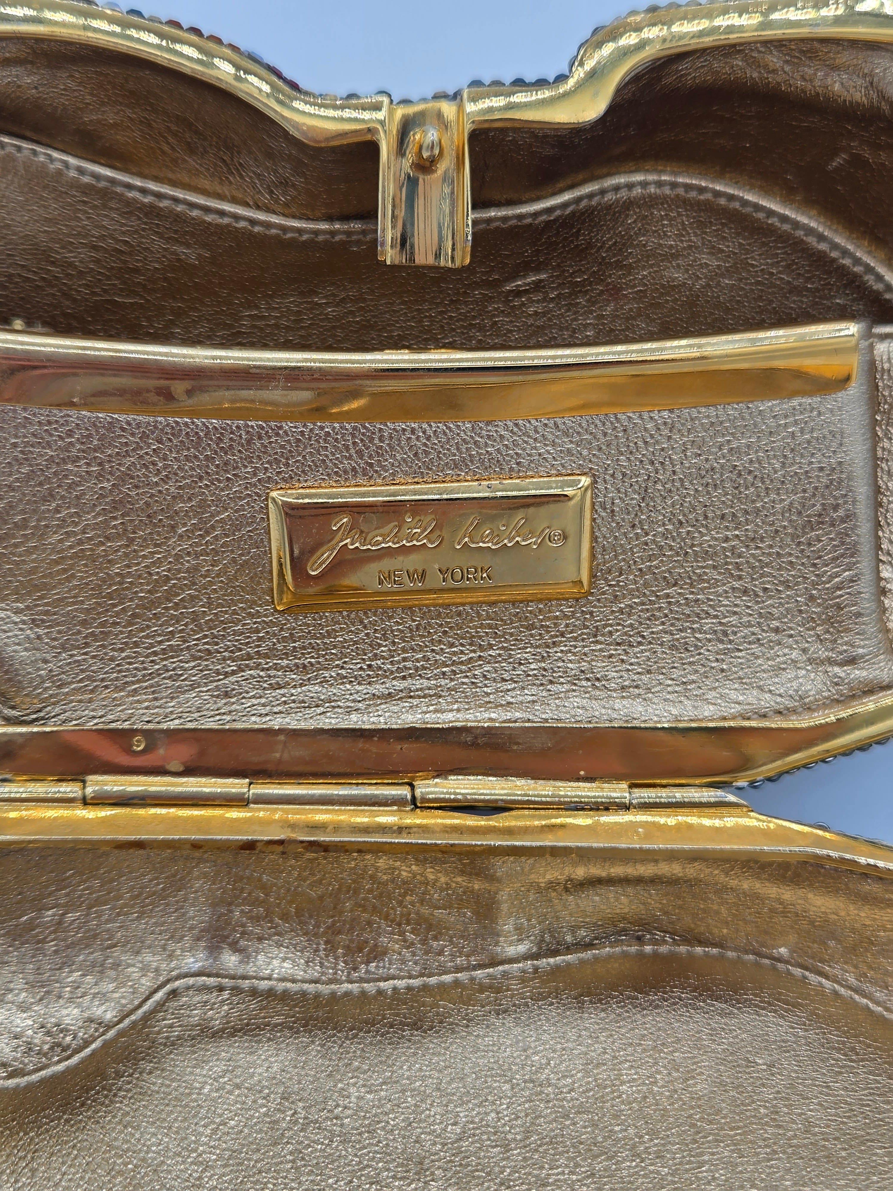 Brown leather case with gold trim and a visible brand logo on a blue background