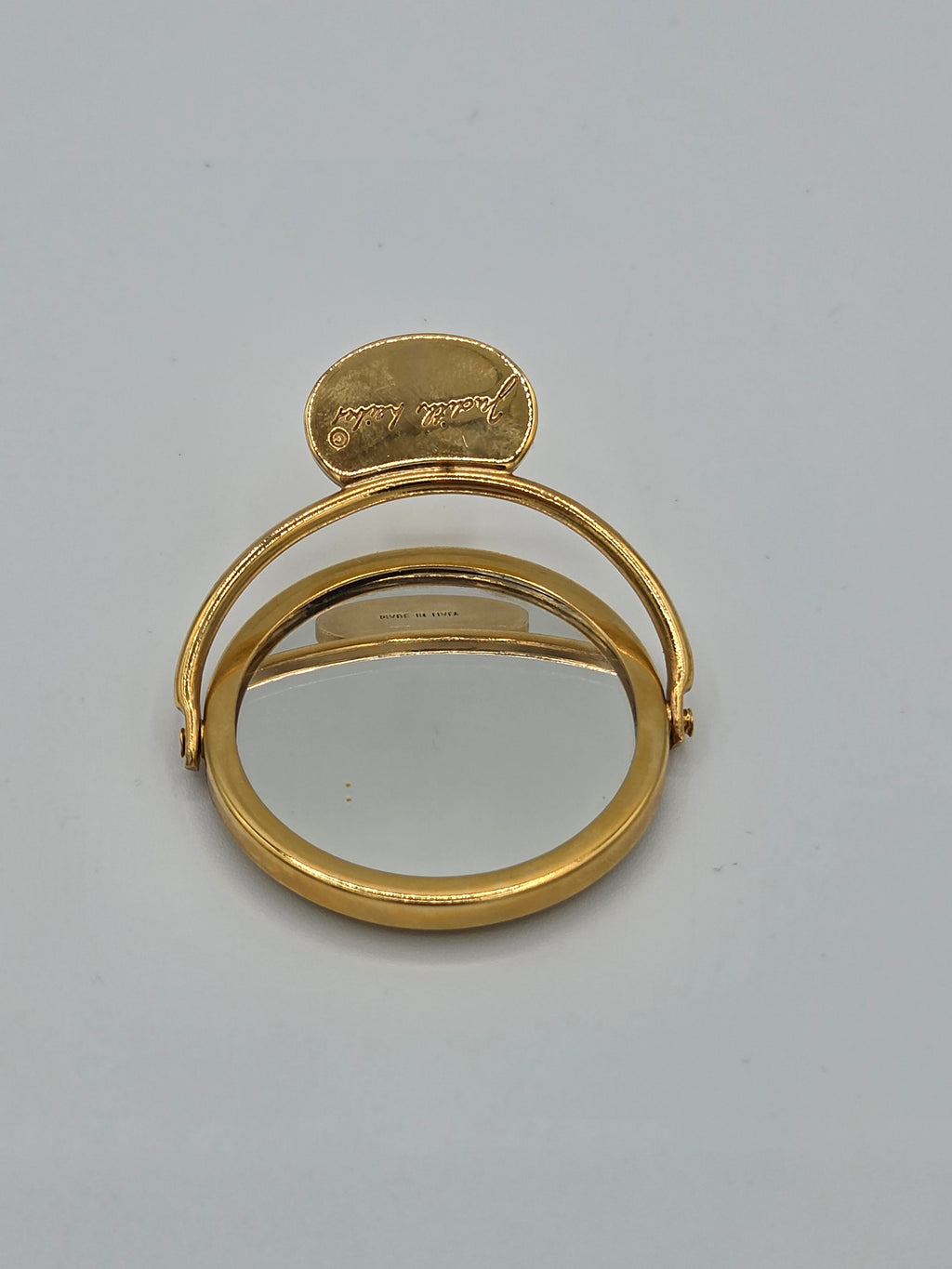 Gold bracelet on a light gray background