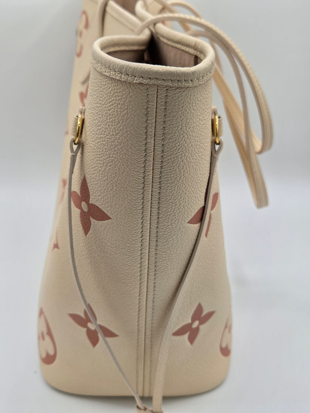 Beige handbag with floral pattern on a white background