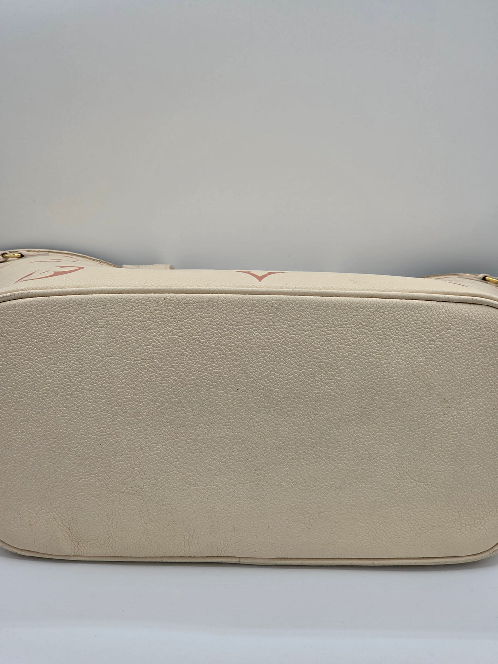 Beige leather wallet on a light gray background