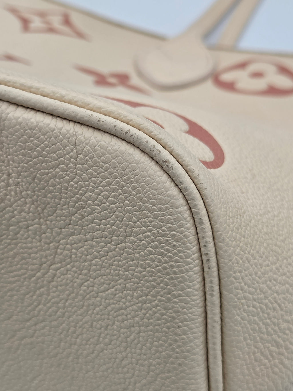 Close-up of beige leather car interior with visible stitching