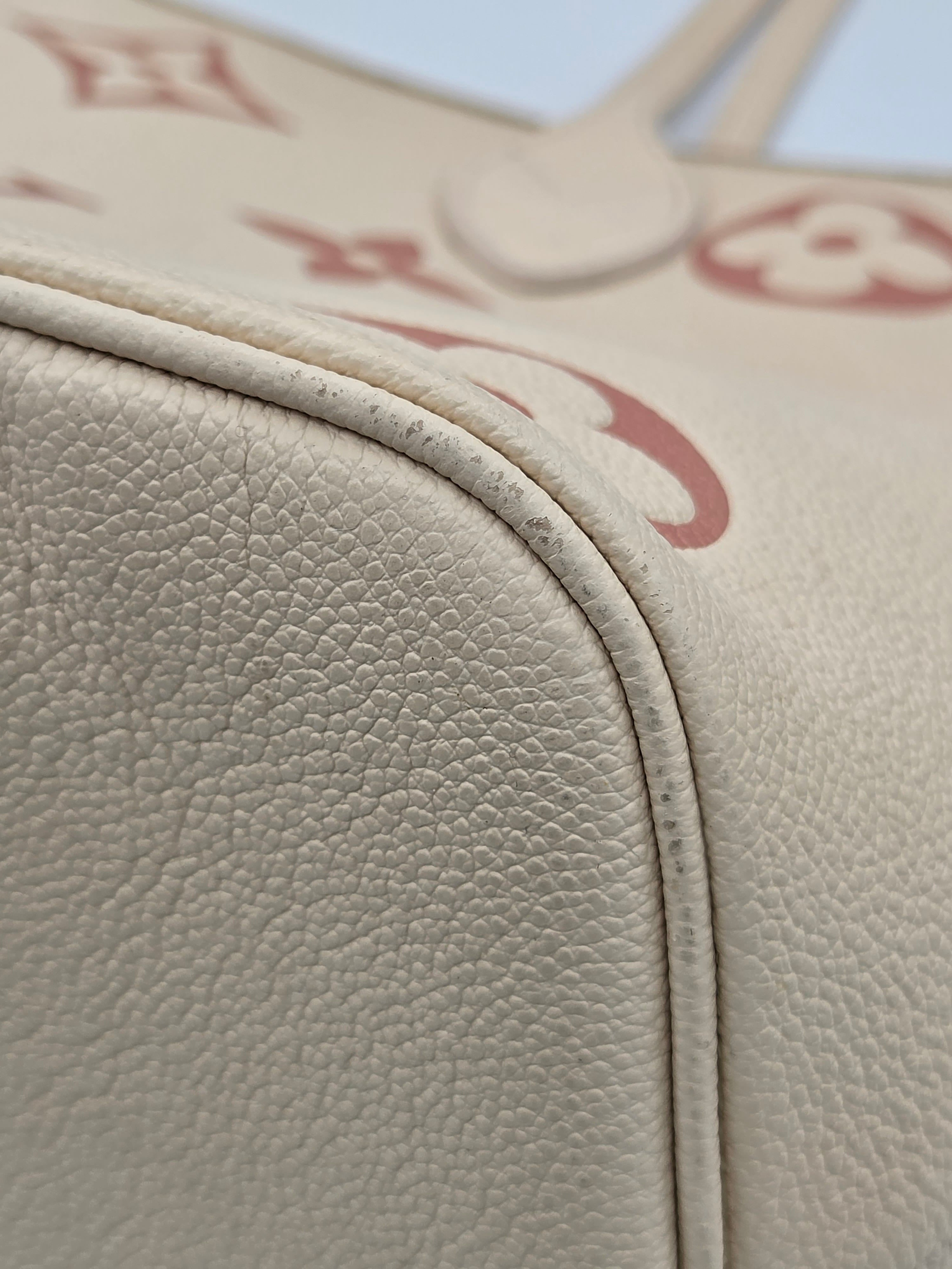 Close-up of beige leather car interior with visible stitching