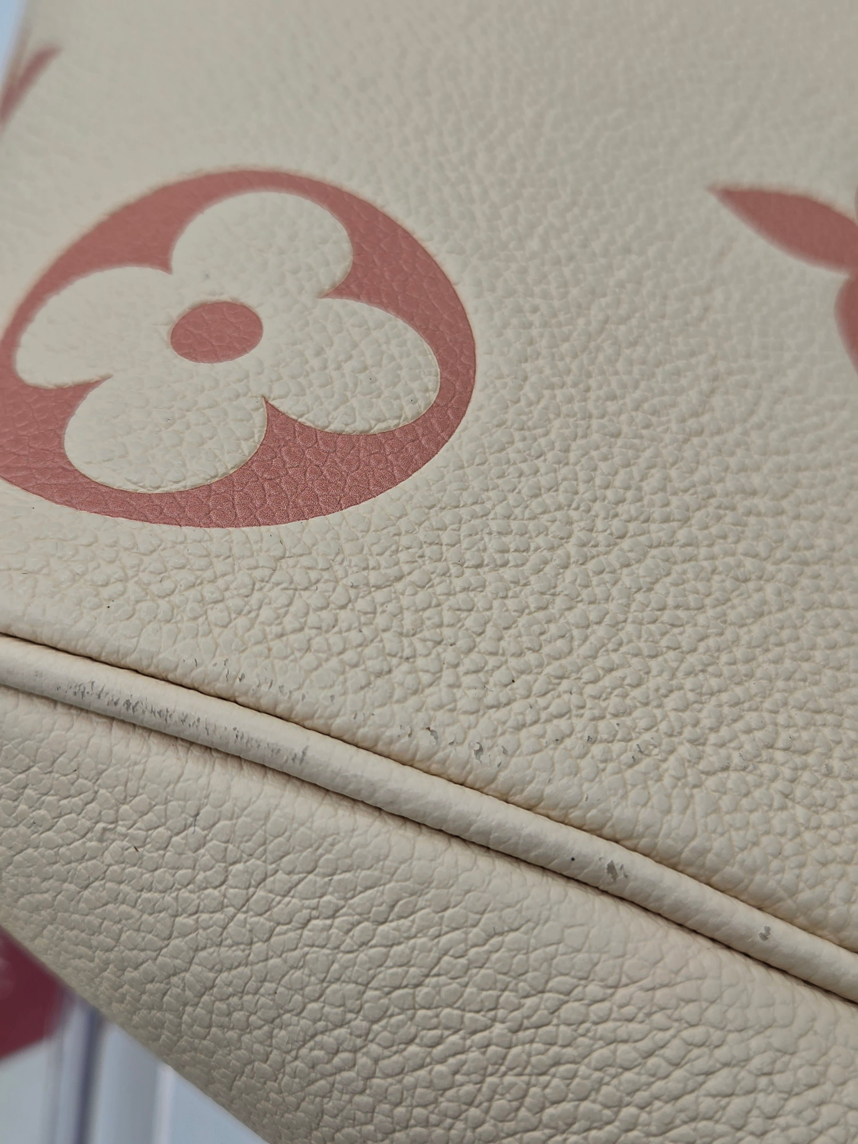 Close-up of a beige textured surface with a red and white logo.
