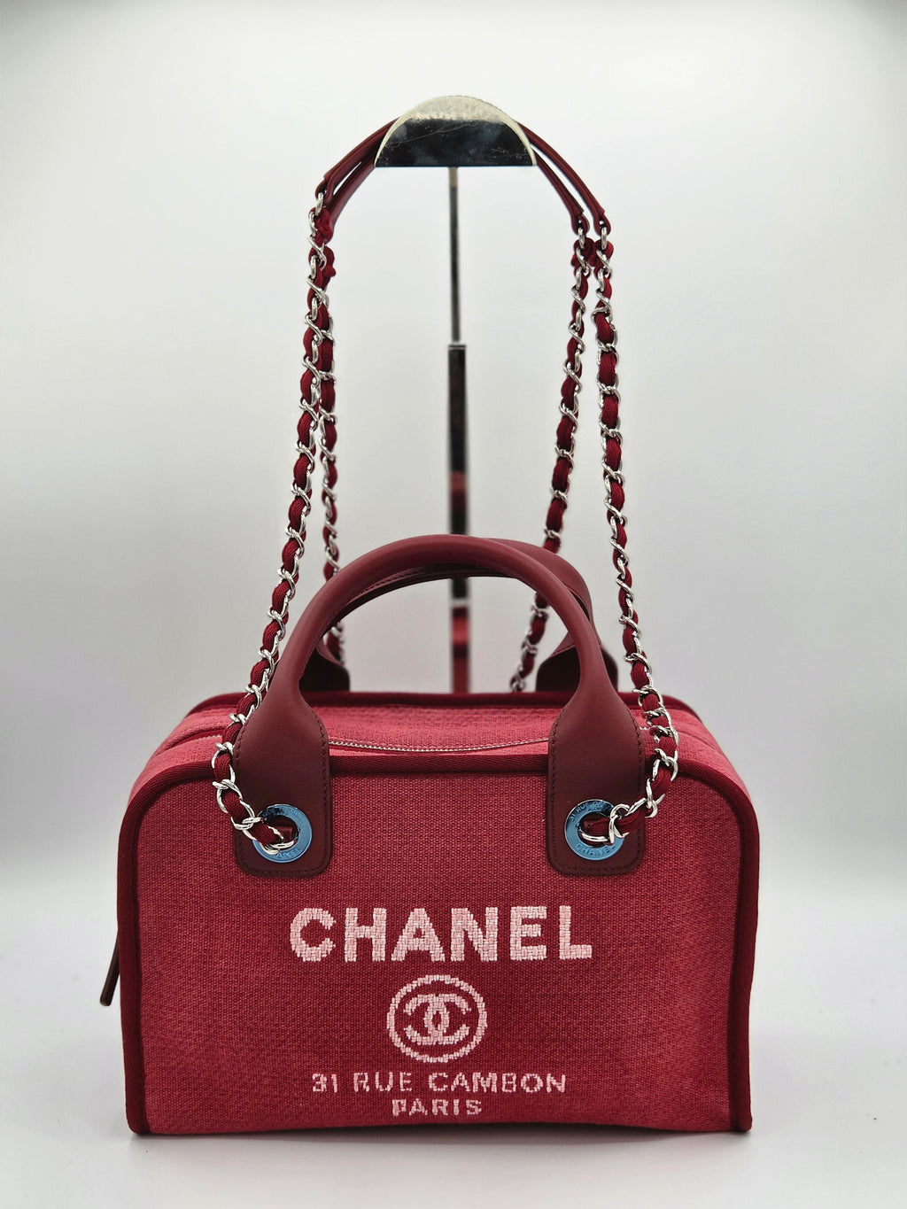 Red Chanel handbag with chain handle on a white background