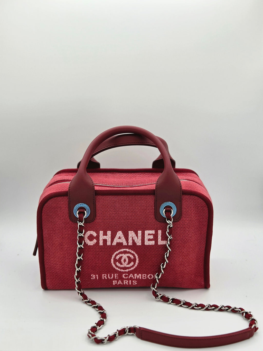 Red Chanel handbag with chain detail on a white background