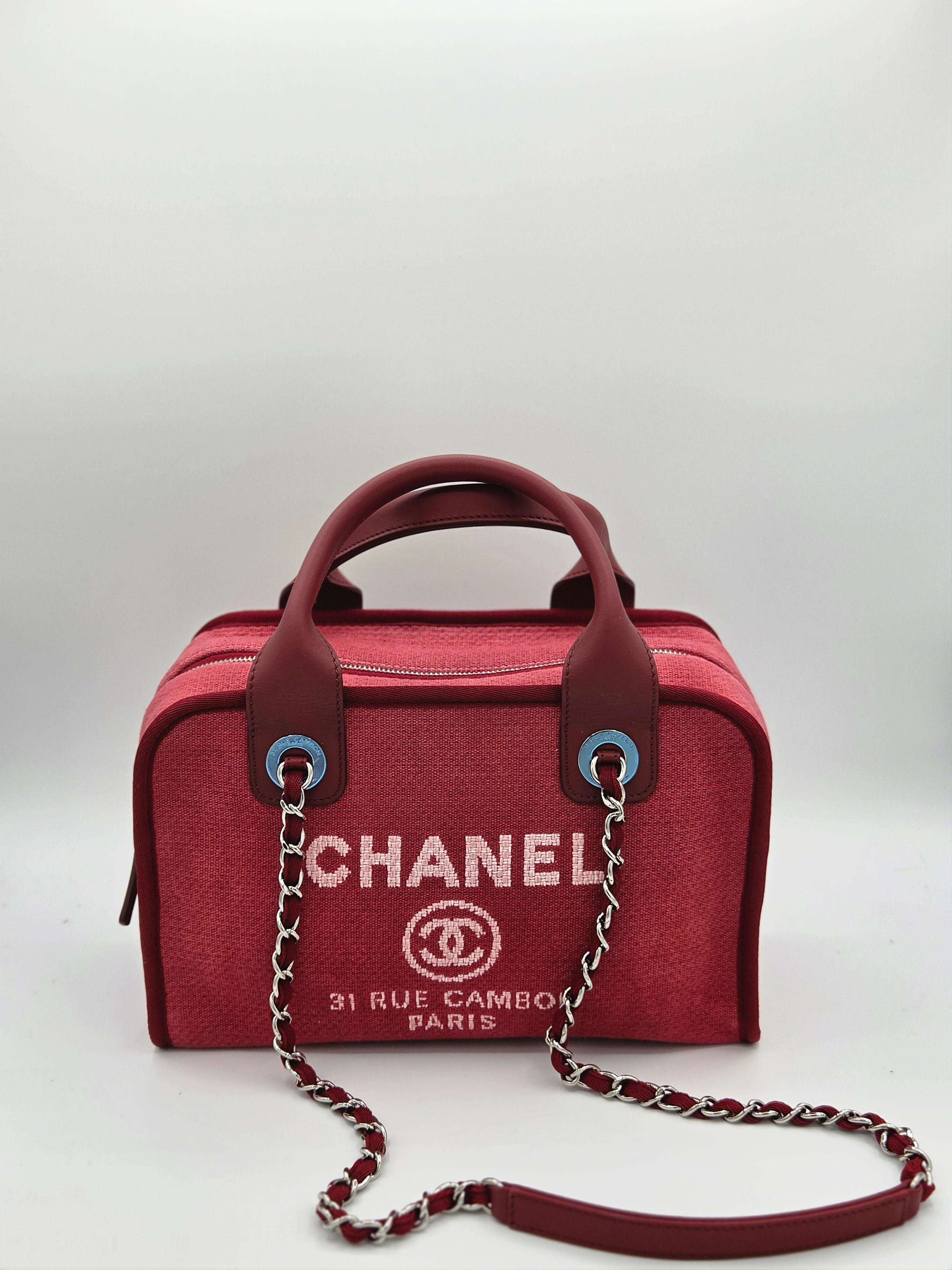 Red Chanel handbag with chain detail on a white background