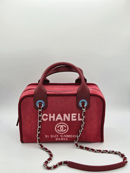 Red Chanel handbag with chain detail on a white background