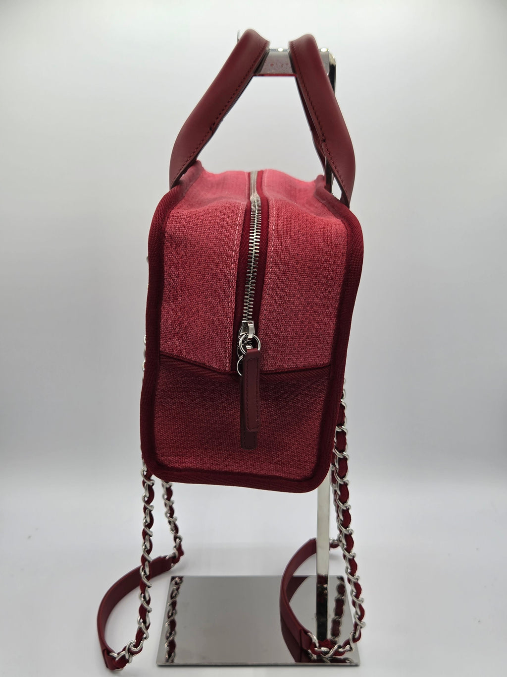 Red handbag with a chain strap on a white background