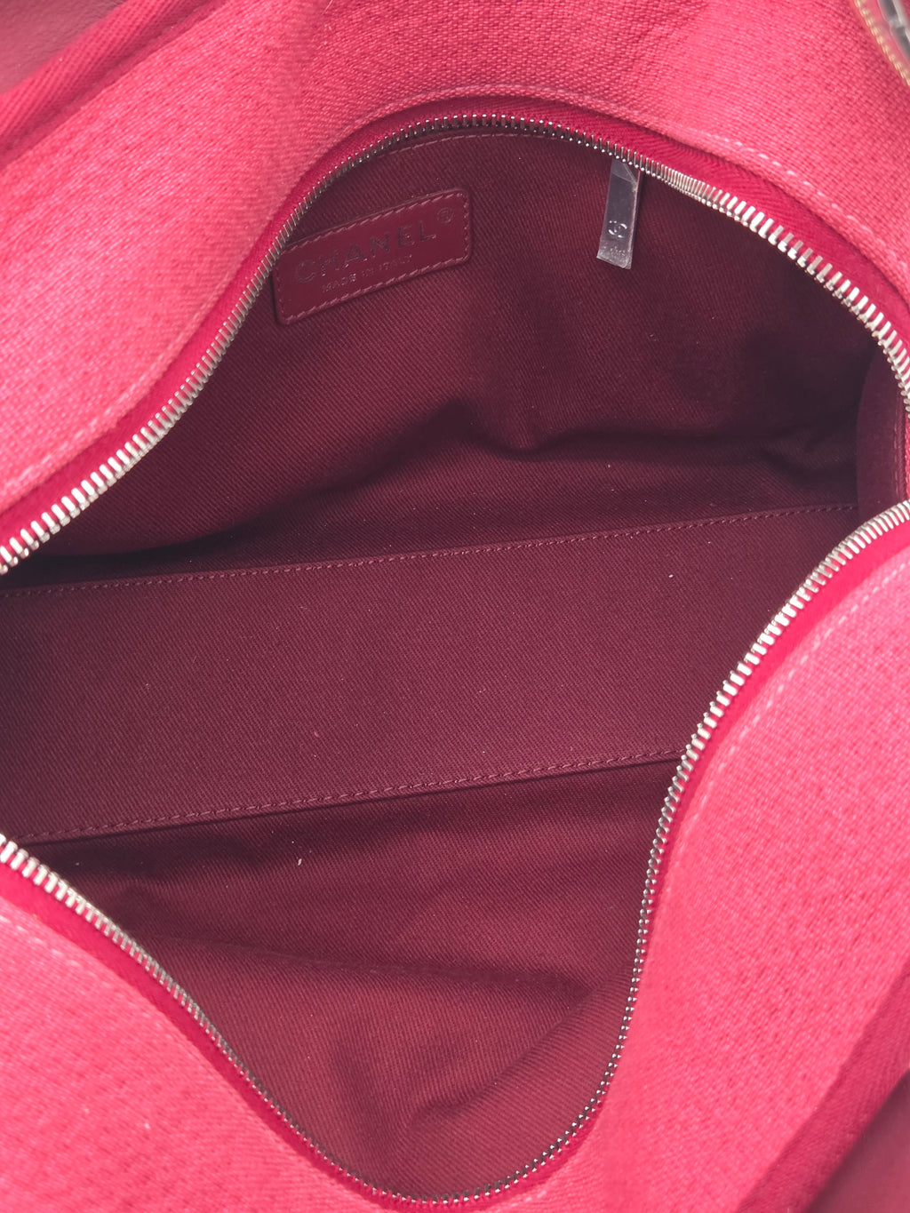 Close-up of a red bag with a visible brand tag.