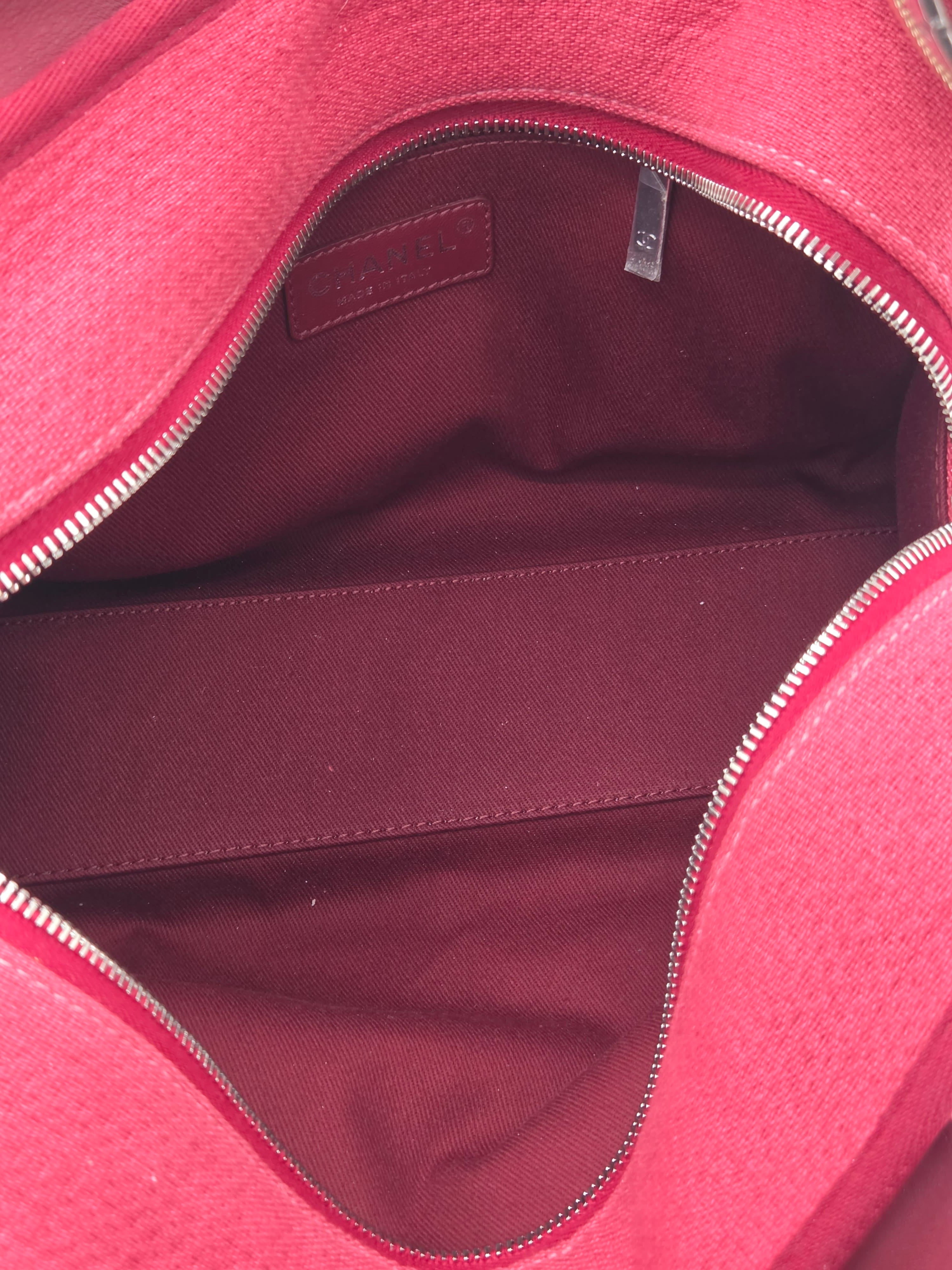 Close-up of a red bag with a visible brand tag.