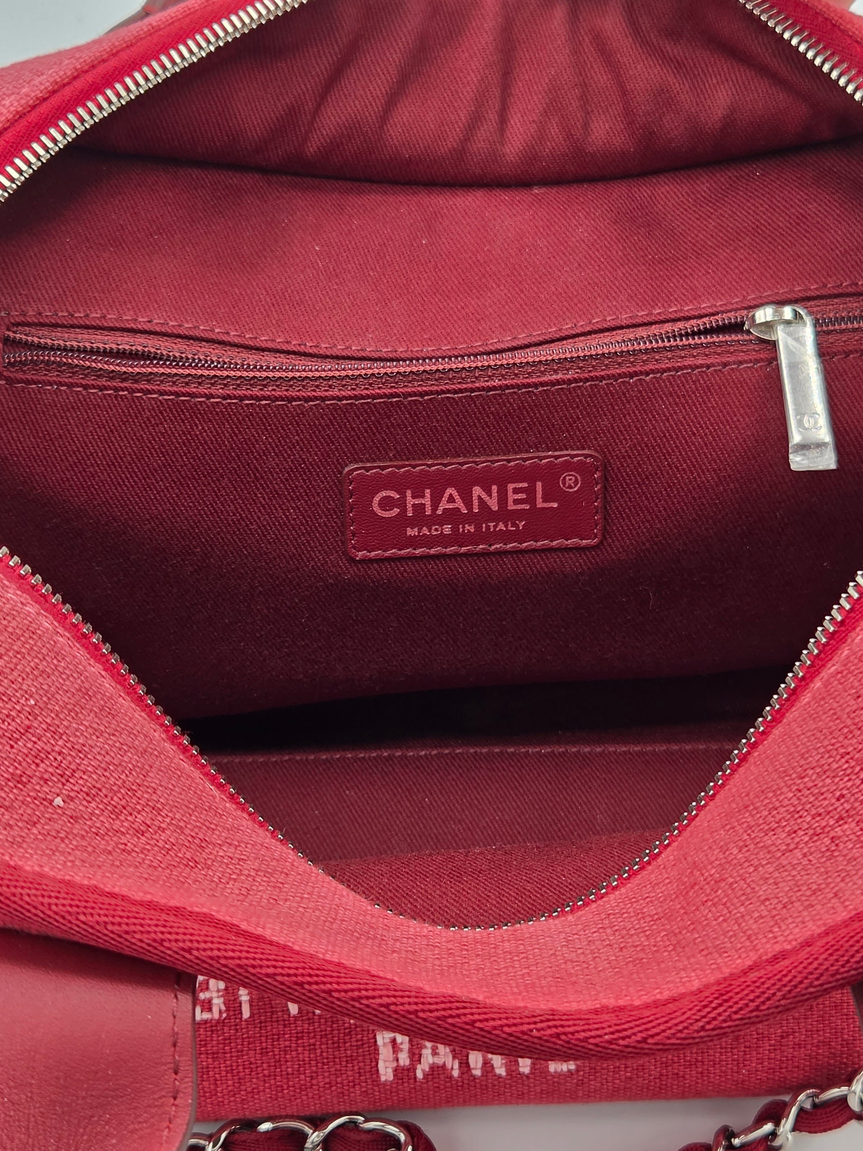 Close-up of a red Chanel handbag with visible branding.