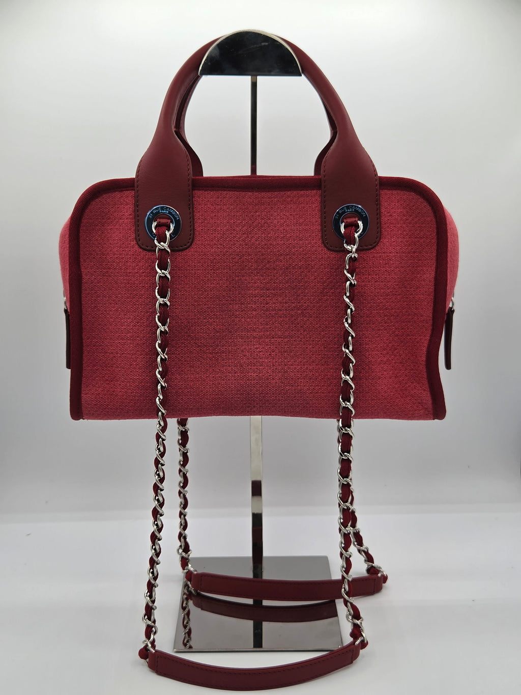 Red handbag with a chain strap on a white background