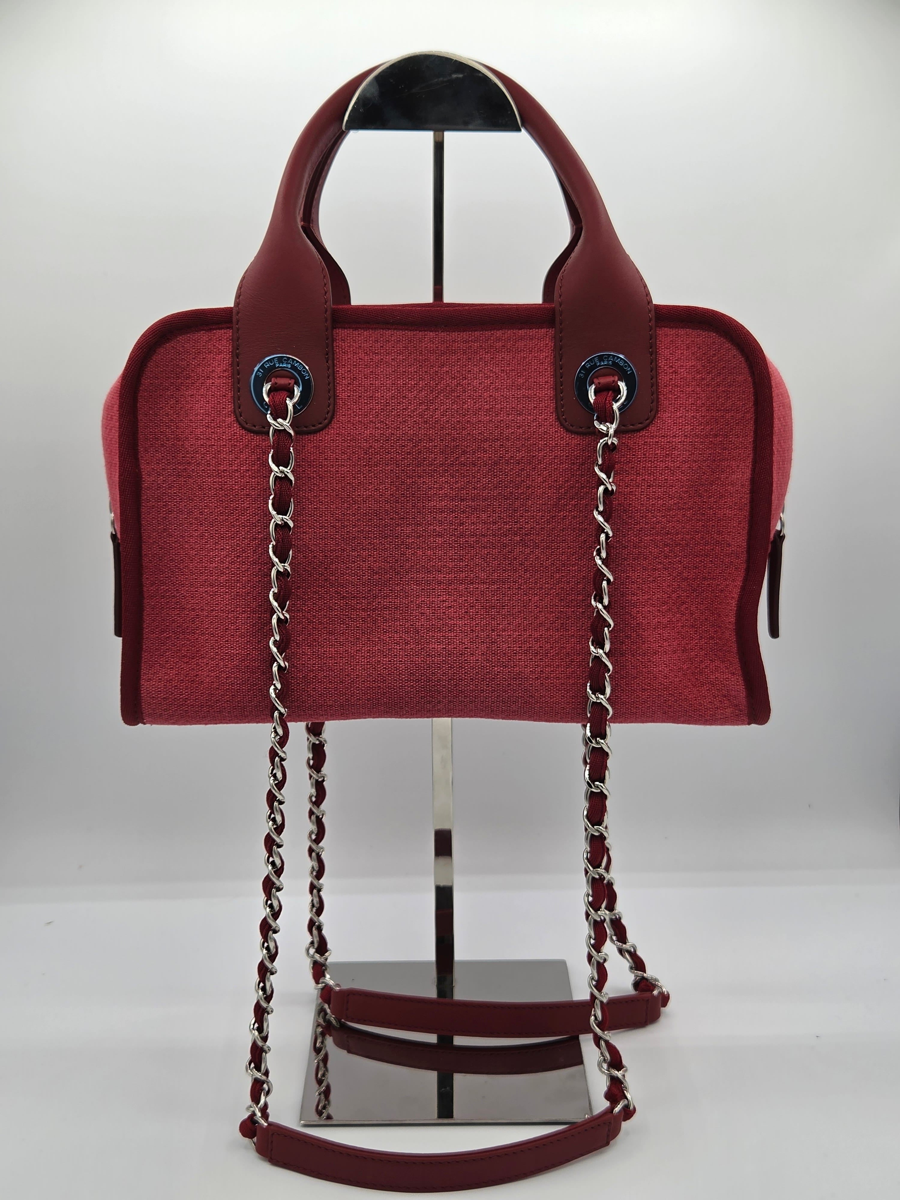 Red handbag with a chain strap on a white background