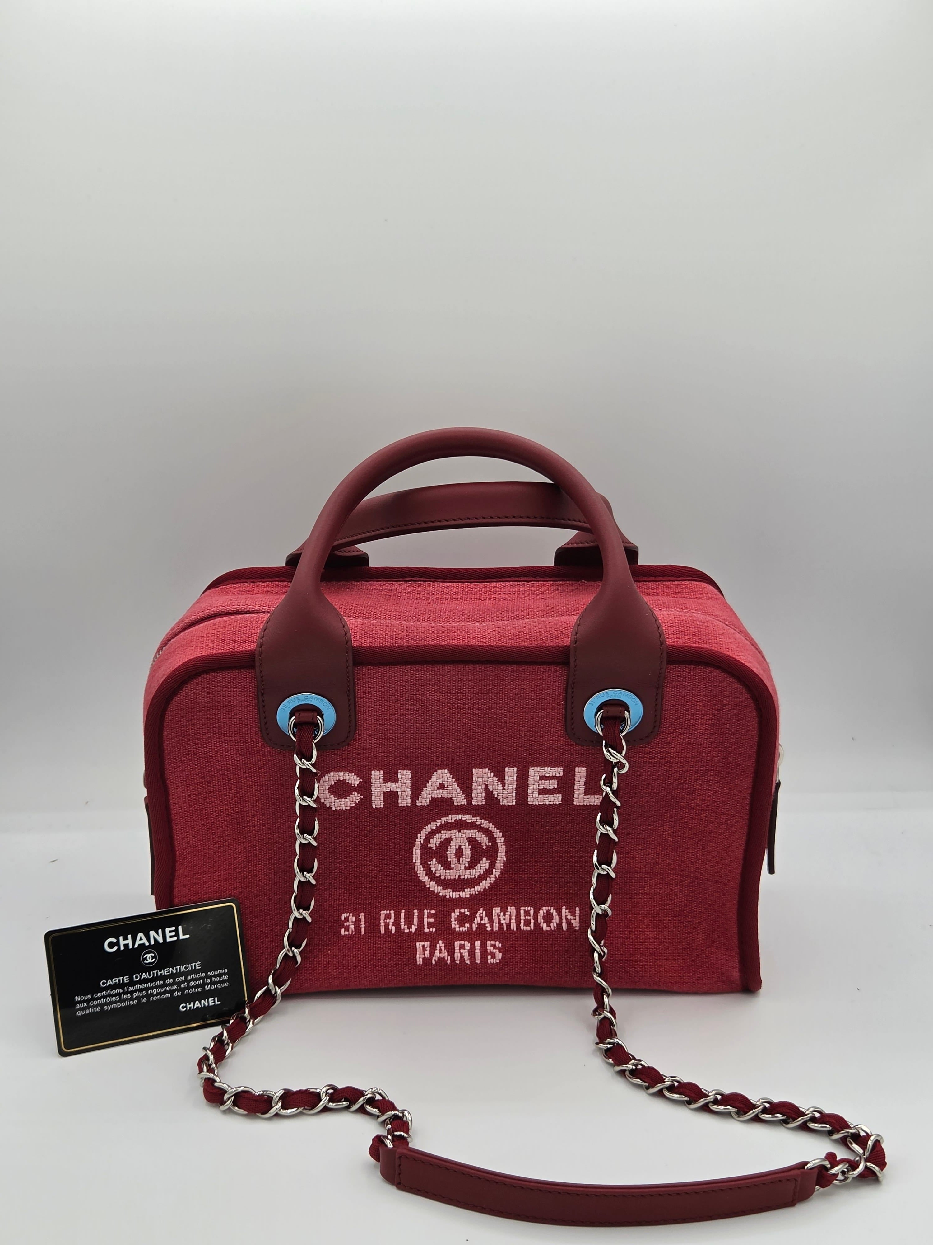Red Chanel handbag with chain strap on a light gray background