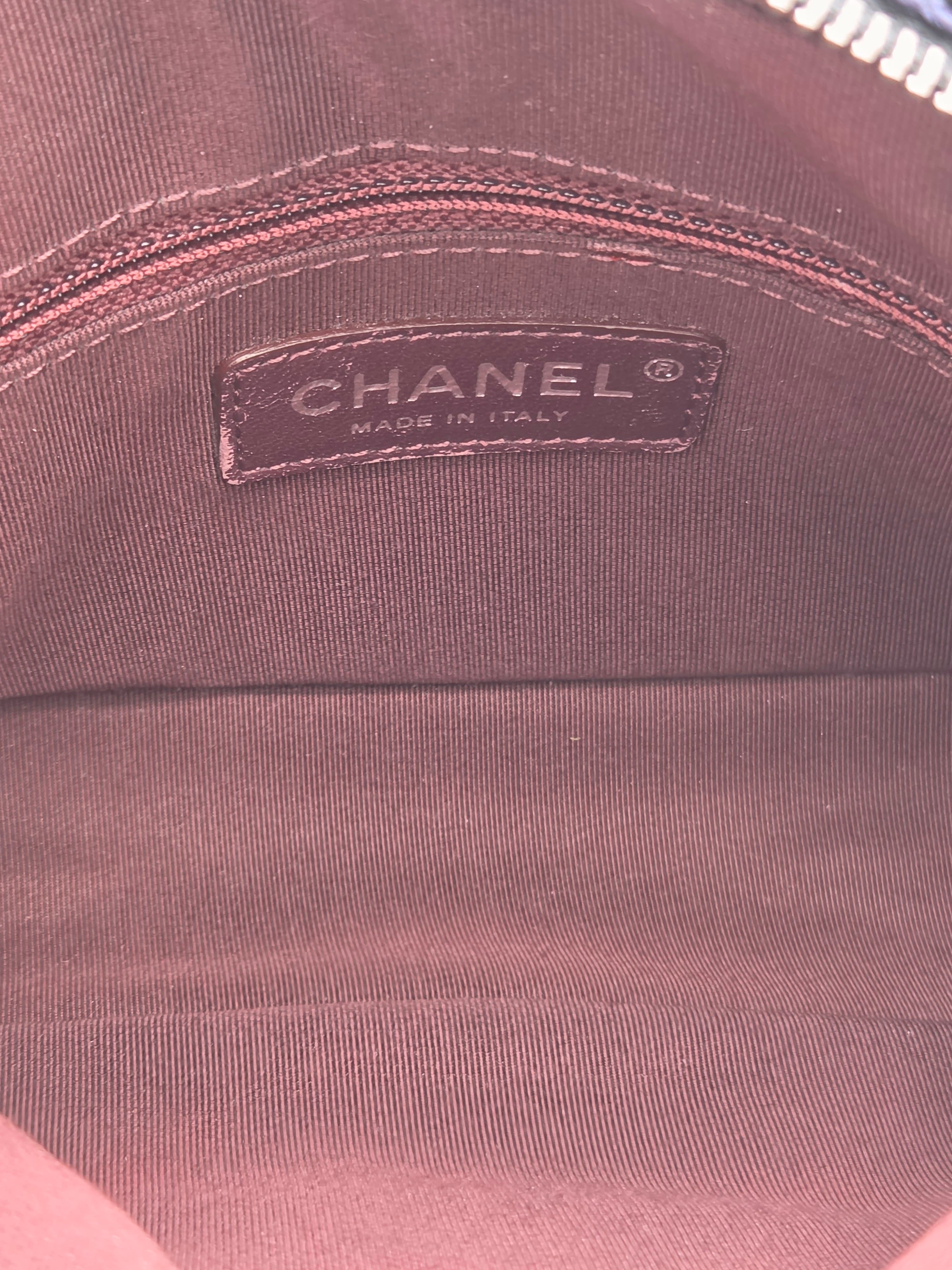 Close-up of a Chanel label on a brown fabric surface