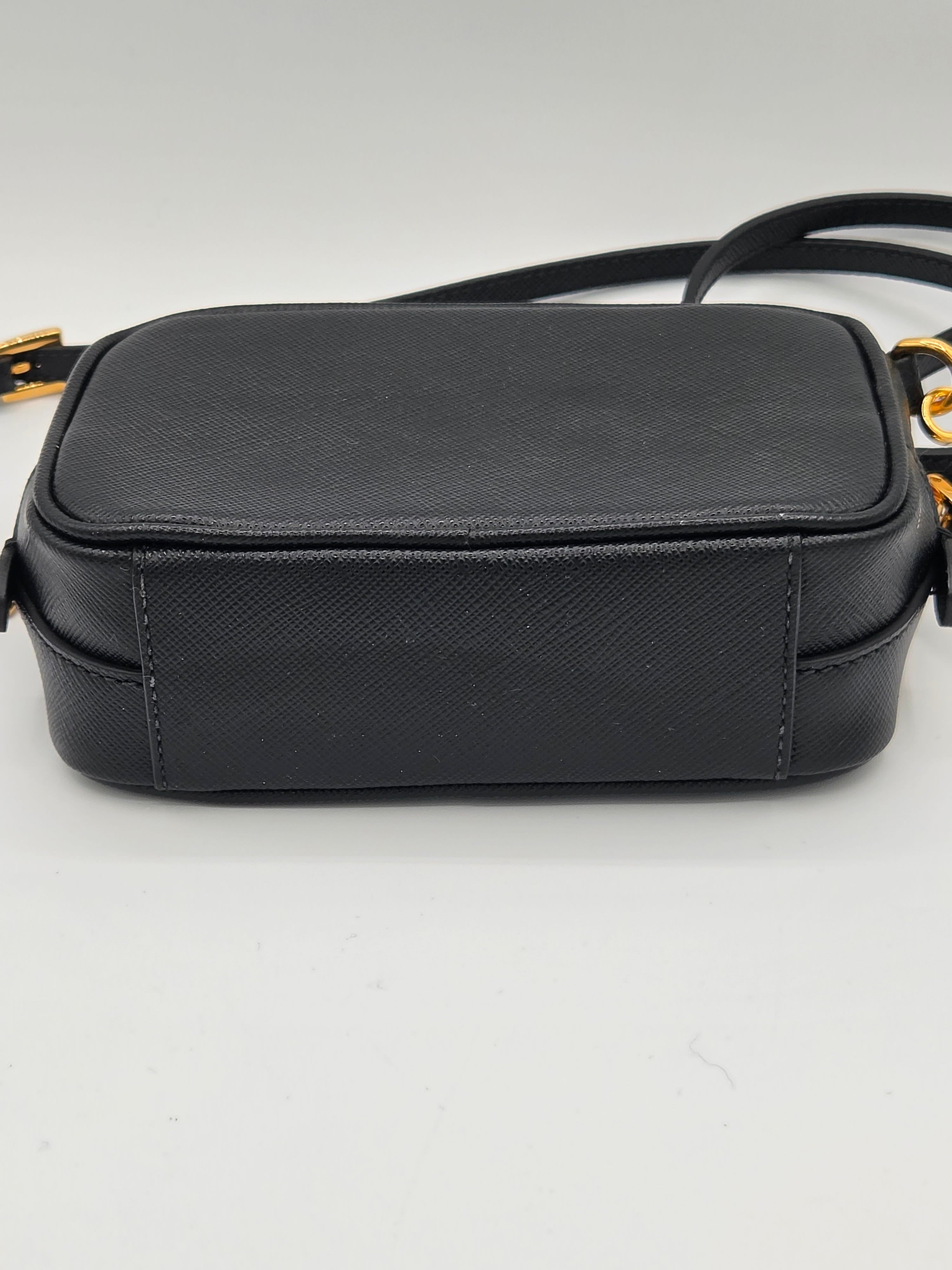 Black leather crossbody bag on a light gray background