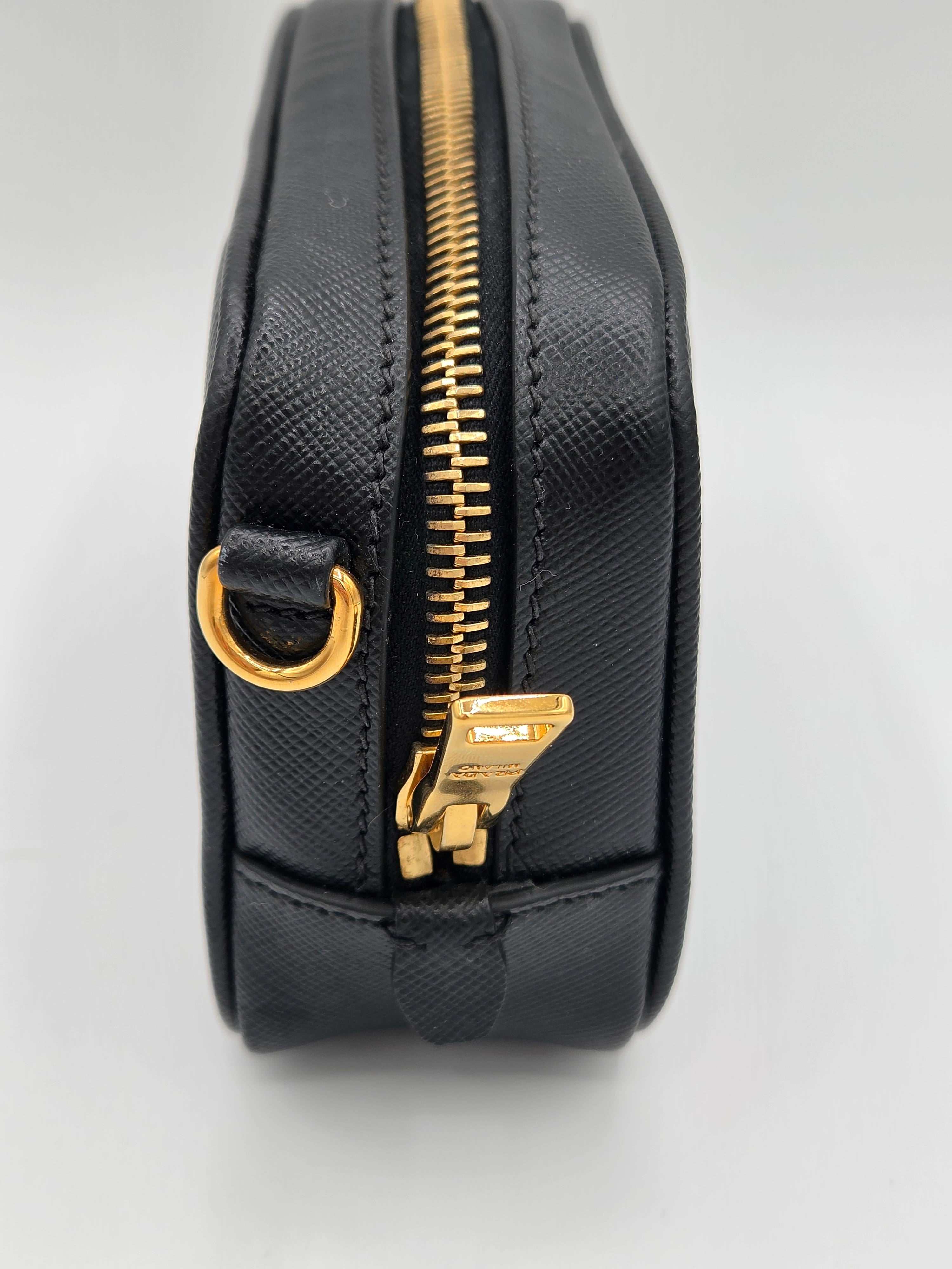 Black pouch with a gold zipper on a light gray background