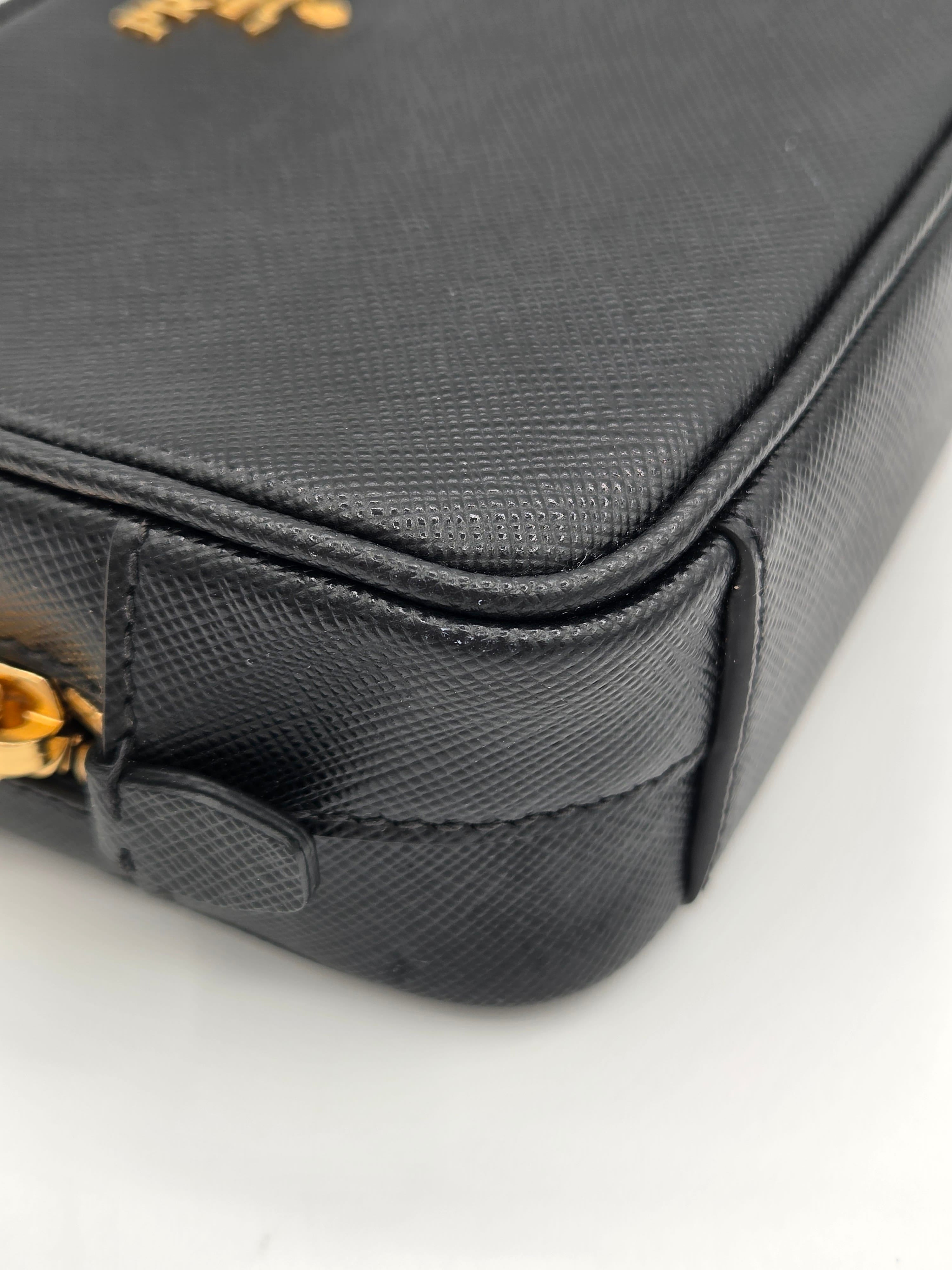 Close-up of a black textured bag with gold accents on a white background