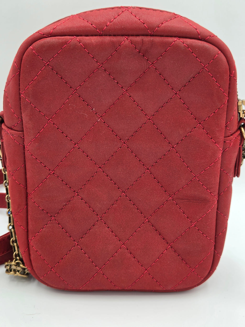 Red quilted handbag on a light gray background