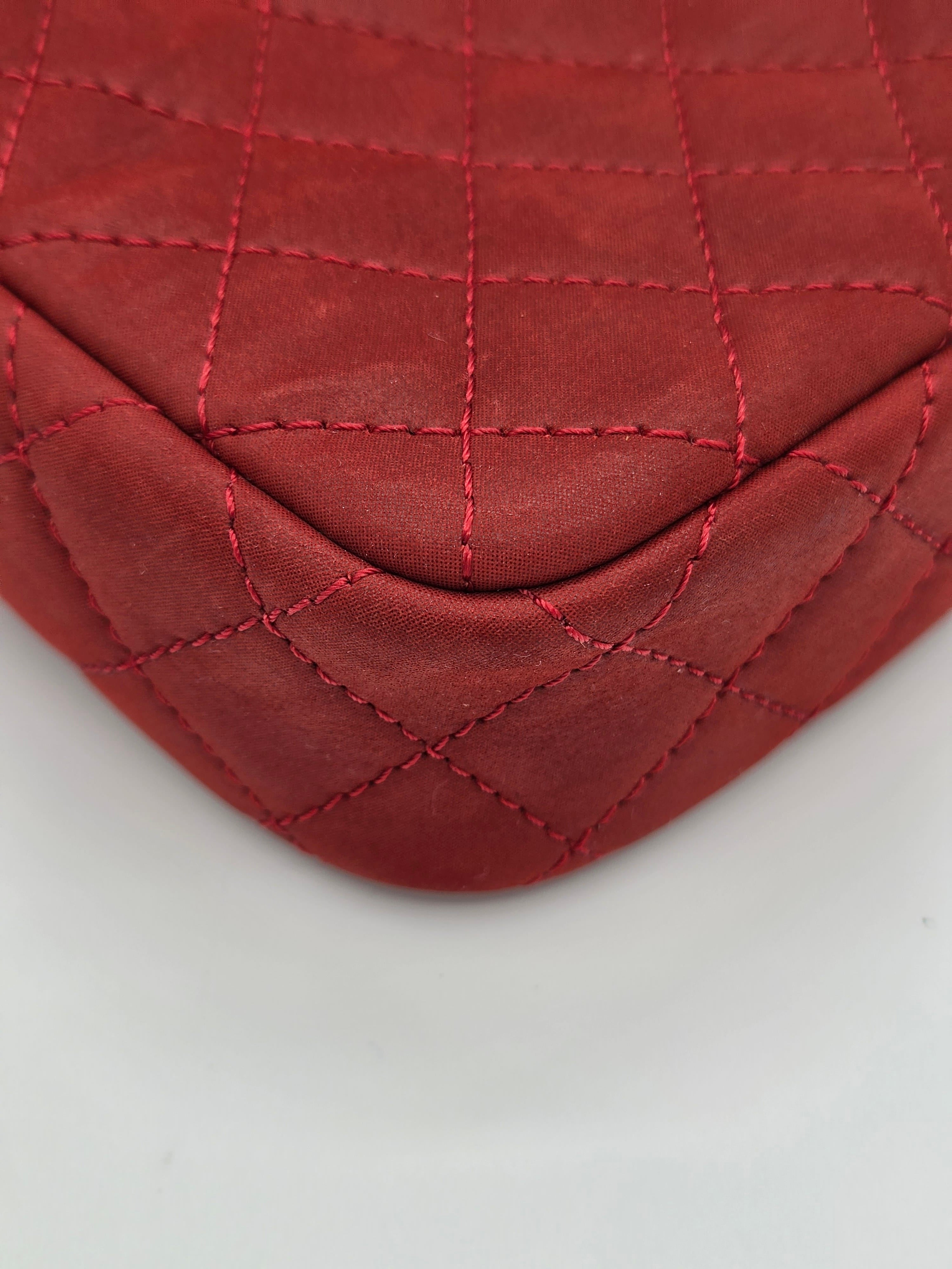 Close-up of a red quilted leather patch on a light gray background
