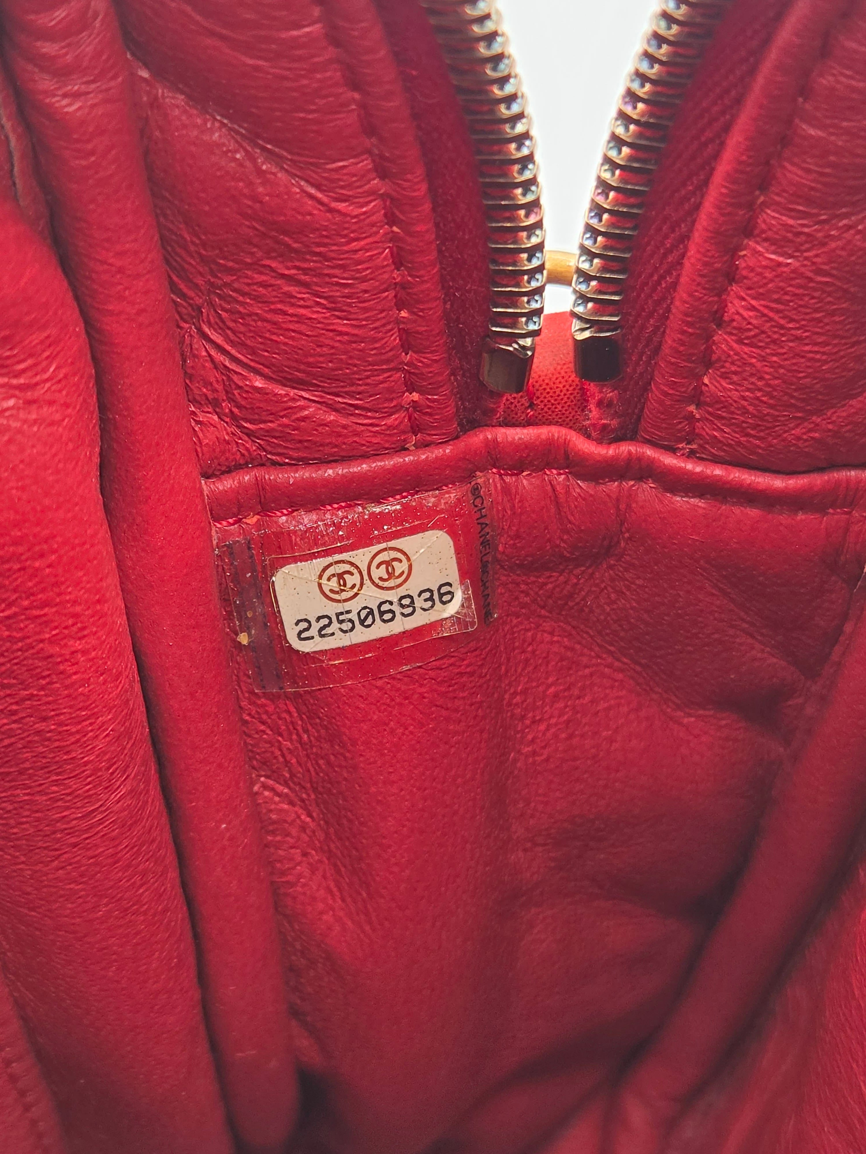 Close-up of a red leather jacket with a visible brand label.